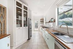  12 Station Street Stanwell Park NSW 2508 Escape the hustle and bustle of the city and immerse yourself in the relaxed beachside village of Stanwell Park with this charming and iconic beach cottage. Perfectly situated just steps away from the beach, this immaculately presented single level home draws inspiration from its coastal surroundings and offers the ideal opportunity to enjoy the sought-after Northern Illawarra lifestyle. Built in the 1950s and renovated over time, this home retains its mid-century charm while featuring contemporary finishes and high-end fixtures throughout. The original timber floor, custom timber joinery, recycled blackbutt, ornate cornices, high ceilings, and exposed beams all add to the timeless coastal cottage vibe of the home. Inside, you'll find four spacious bedrooms, all with built-in wardrobes, including a master bedroom retreat with its own private access, ensuite, and courtyard. The home features two custom-built, newly renovated bathrooms with porcelain tiles and basin, large windows, French doors, and lofted high ceilings with exposed rafters that create a light and airy feel all year round. The impressive outdoor entertaining area is perfect for hosting friends and family. The wraparound alfresco deck flows seamlessly into the kitchen, fire pit, and immaculate gardens, making it the perfect place to enjoy those summer evenings. The indoor fireplace provides warmth and comfort during the cooler months. The fully fenced yard offers plenty of space for children and pets to play, and the outdoor shower is perfect for rinsing off after a day at the beach. This home is ideally located, with all of Stanwell Park's amenities at your doorstep, including the beach, playground, cafes, restaurants, and public transport. Enjoy the quintessential coastal lifestyle of the Northern Illawarra, with endless opportunities for surfing, bushwalking, swimming, and dining out at one of the many great cafes and restaurants in the area. The Royal National Park is just a 10-minute drive away, while Sydney CBD is approximately one hour to the north and Wollongong CBD is 30 minutes to the south. Don't miss your chance to secure one of the few remaining mid-century beach houses in the Northern Illawarra.  