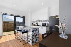  7 Queenie Way Cranbourne West VIC 3977 $489,000 - $537,000 Step into modern comfort and superb lifestyle convenience within this crisp and contemporary three-bedroom Quarters Estate residence, which delights with contemporary design, stylish finishes and exciting affordability for starters, young families, downsizers and investors. Beyond a chic facade, the home is absolutely move-in ready with an alluring colour palette, plush chocolate carpeting in the bedrooms and woodgrain in the living zone, quality window furnishings with split-system heating and airconditioning throughout. Immaculate open-concept living and dining is awash in natural light and flows into the modern kitchen with island breakfast bar, stainless-steel oven, gas cooktop and offset monochromatic subway tiling. Glass doors open to a sun-splashed private alfresco patio directly off the dining space, which both expands the square footage of the home while offering a tranquil locale to relax, barbecue and host friends on sunny weekends. All three bedrooms are cosseted in quiet on the upper level of the townhouse encircling the second living area / study and share a full bathroom and master ensuite with freestanding rectangular basins and charcoal ceramic tiling, as well as a tub in the family bathroom for those end-of-day bubble baths. Sensationally situated in steps to brand-new Quarters Primary School and Cranbourne West Secondary College, with recreational facilities, parks, playgrounds, public transport and a choice of shopping centres surrounding, this turnkey gem includes a garage and additional parking bay. 