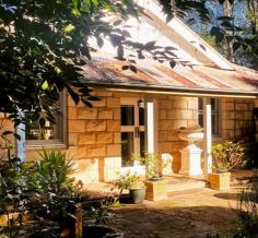  17-19 Panorama Rd Bundanoon NSW 2578 $1,950,000 - $2,145,000 Historic circa 1900s sandstone cottage set amongst a stunning Edna Walling designed garden offering old world charm and scope for so much more. Enter via the privately screened gate over the engineered bridge and through the gorgeous grounds before finding yourself at the cosy two bedroom residence, the ultimate weekend hideaway, holiday rental or forever home. Cottage is mostly in original condition offering two bedrooms and a generous well proportioned bathroom and separate laundry / mudroom, a very usable space; Open plan living / dining flows to both the front stone terrace with centrally placed water feature and the side screened verandah perfect for hot summer nights, and flows seamlessly to the large kitchen with Aga, in need of some renovation plus additional access to the rear verandah; Heating is via the s/c wood fire with modern conveniences blending with charming finishes such as all town services, timber casement windows, French doors, high ceilings and constructed from Bundanoon Sandstone, all adding to the uniqueness of this cottage; With subdivision potential a real possibility (STCA) and / or space at the rear of the property for a second dwelling if desired, this elevated sweeping lawn area offers distant local views and privacy from the original residence; Breathtaking gardens wrap this home in privacy with dappled sunlight warming the home and verandahs. Offering a series of garden rooms, inclusive of European and Australian species, rainforest oasis and heritage orchard, a great place for children and adults alike to explore. Minutes to the village and all Bundanoon has to offer, in a blue ribbon street ‘Estoril’ will capture your heart. 