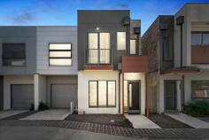  7 Queenie Way Cranbourne West VIC 3977 $489,000 - $537,000 Step into modern comfort and superb lifestyle convenience within this crisp and contemporary three-bedroom Quarters Estate residence, which delights with contemporary design, stylish finishes and exciting affordability for starters, young families, downsizers and investors. Beyond a chic facade, the home is absolutely move-in ready with an alluring colour palette, plush chocolate carpeting in the bedrooms and woodgrain in the living zone, quality window furnishings with split-system heating and airconditioning throughout. Immaculate open-concept living and dining is awash in natural light and flows into the modern kitchen with island breakfast bar, stainless-steel oven, gas cooktop and offset monochromatic subway tiling. Glass doors open to a sun-splashed private alfresco patio directly off the dining space, which both expands the square footage of the home while offering a tranquil locale to relax, barbecue and host friends on sunny weekends. All three bedrooms are cosseted in quiet on the upper level of the townhouse encircling the second living area / study and share a full bathroom and master ensuite with freestanding rectangular basins and charcoal ceramic tiling, as well as a tub in the family bathroom for those end-of-day bubble baths. Sensationally situated in steps to brand-new Quarters Primary School and Cranbourne West Secondary College, with recreational facilities, parks, playgrounds, public transport and a choice of shopping centres surrounding, this turnkey gem includes a garage and additional parking bay. 
