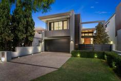  2A Armstrong Rd Applecross WA 6153 With its enviable street appeal and stunning open plan design throughout, this impeccable home will tick all the boxes and its versatile floor plan will suit families of all ages! Boasting sleek lines, high ceilings and quality inclusions throughout, this home is ready for its next owners to move straight in and enjoy! Completed in 2018, this contemporary residence represents an uncompromised level of quality and design. Upon first entering the statement portico, the level of detail is evident. Stepping through into the home, a sense of space is immediately apparent from the double height ceilings in the entrance foyer. The central courtyard with glazed bifold doors basks in natural light and a provides a sense of tranquillity to the home and the perfect entrance to the open plan lounge, kitchen with scullery and dining area. This flows onto the entertaining alfresco with louvres, fan, wired speakers in the cedar lined ceiling and built-in outdoor kitchen with stone benchtop and bar fridge. The ground floor also comprises a study which could also be used as a bedroom, theatre or play room, mud room and powder room. The kitchen forms the heart of the home and has been finished to the highest specification incorporating double wall mounted ovens and a wide induction cooktop. The adjoining scullery ensures easy and mess free preparation and includes a plumbed recess for a double door refrigerator, extra-large walk-in pantry and ample cabinetry and drawers throughout. Ascend the staircase and you will realise the clever design of the bridge which separates the master and minor bedrooms alongside the impressive two-storey void. The master bedroom is positioned towards the front of the home with spectacular tree top views, an enviable dressing room and ensuite bathroom with full height tiling and double vanities. There are three additional bedrooms each with walk-in robes, second bathroom with family bath and double vanities, laundry and drying balcony. There is also another upstairs living area which could be used as a play room or tv room with storage cupboard. The rear yard is ideal for kids and pets yet low maintenance with a swimming pool with water blade and water spouts and a grassed area with inbuilt bench seat. There is also an outdoor shower and outdoor powder room, all surrounded by tranquil, easy care landscaping. There has been no expense spared in this luxury home with additional features including smart wiring, ducted reverse cycle air conditioning, security alarm, video intercom, shutters and an abundance of built in storage. This home is positioned on a quiet, jacaranda lined street within a lovely community. Near new homes of this calibre rarely become available. This stunning home is ready for the next owners to move straight in and enjoy without the time and stress often involved in the building process. 
