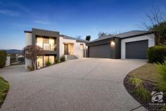  58 Avondale Drive Wodonga VIC 3690 $1,400,000 From the moment you set your eyes on 58 Avondale Drive, you will be in awe of the attention to detail and thoughtful design of the property. This remarkable Peter Howard-built residence combines spacious living, modern elegance, and breathtaking views of Wodonga. Nestled in the highly sought-after Cambourne Park Estate, this property offers an unparalleled opportunity to experience luxurious family living at its finest. Externally, the home has a commanding street presence that sets the tone for the rest of the property. Situated on a 1275m2 block, the home is set towards the back for privacy and to take advantage of the views to the rear of the block. The three-car garage at the front of the home provides plenty of storage, as well as the added bonus of an extensive under-house space. A ten-meter saltwater pool has established hedges around it for complete privacy as well as an alfresco space on ground level. The grey-toned palette of the exterior is carried throughout the interior of the home for a continuous and consistent design. Set over two levels, the four-bedroom, two-and-a-half-bathroom home is perfect for the growing family. With the main living areas and bedrooms upstairs to make the most of the stunning views, the downstairs rumpus room with half bath is perfect for a kid's playroom, teenagers retreat or fifth bedroom. With a separate formal lounge at the front of the home, the main open plan kitchen and living space is the heart of the home and was built to take full advantage of the surrounding views. The balcony off the living space is an entertainer's paradise that features an island bench with a built-in gas BBQ, bar fridge and spectacular views over the pool. The large master suite has a walk-in robe and updated ensuite that continues the grey tones of the rest of the home. The three remaining bedrooms are generously sized with built-in robes, fresh carpet throughout and are serviced by the large family bathroom. Key features of the property include: -4.5 KW of Solar -Ducted heating and cooling throughout -Irrigation system -Square set cornices Don't miss your chance to own this exceptional property that combines generous living spaces, modern comforts, and stunning views. Experience the pinnacle of luxury living at 58 Avondale Drive, Wodonga. 