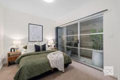  13 Florey Pl Adelaide SA 5000 Built in 2003, this beautifully presented tri-level townhome is ideally positioned, walk to the tram on King William Road, taking you into the CBD & Glenelg. There is easy access to two, 7-day, late night IGA supermarkets, one in Gilbert St, the other in Hutt St. Stroll to the popular ‘Greek on Halifax’, Herringbone, La Trattoria & cafes along Halifax & Gilles streets. Entry is via either from Howard Florey St, or Catherine Helen Spence St. The home is set in a neat & quiet row of townhouses, offering perfect north/south orientation. Direct access into the home is provided from the double-length garage with an automatic roller door. The laundry facilities are in the garage, complete with white laminate sliding doors to extensive storage including provision to store your rubbish bins in a nook under the stairs. From the moment you step inside, you are sure to be impressed by the fresh contemporary décor, featuring new latte-toned plush pile carpet & white walls. Middle Level:- There are 2 double bedrooms, both fitted with white laminate sliding robes. The main bedroom enjoys large picture windows, inviting the northern winter sun, whilst bedroom 2 offers a sliding door (+ screen) opening to a tiled-floor open-air atrium. Ideally, there are 2 matching bathrooms, one on either side of the bedrooms. A twin-door linen press is provided, along with the control panel for the zoned, ducted reverse-cycle air-conditioning system. Upper Floor:- The well-equipped kitchen is fitted with crisp white laminate cupboards & a charcoal-toned laminate benchtop. The kitchen windows provide good natural light from the open void. There is an electric cooktop, stainless steel under-bench oven, Dishlex dishwasher, pantry & appliance cupboard. The kitchen is lined with newly polished timber floorboards, adjoining spacious & light-filled, north-facing open plan dining & living areas, including LED downlights. Floor-to-ceiling windows invite loads of natural light & a sliding door (with screens) open to a tiled floor balcony with frosted glass balustrade – the ideal spot for alfresco dining. Extras Include:- Ducted r/c air-conditioning, insulated ceilings & walls, custom fitted blinds, hard-wired smoke alarm & NBN capability. 