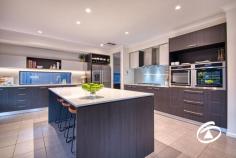 20 Oakview Blvd Narre Warren North VIC 3804 $1,750,000 - $1,800,000 Situated in an exclusive tree-fringed boulevard at the highly sought-after Oaktree Rise Estate, number 20 Oakview Boulevard projects a commanding presence from its wide-fronted 884m², elevated setting. Of immediate attraction is its superb three-car garage with drive-through access for further vehicle storage. A wide, exposed aggregate parking apron permits ample family or guest parking too. Step inside and a wonderful light-filled and spacious interior beckons. Features include an independent lounge with stunning views across the adjacent wetlands, a fully fitted and beautifully functional home office/study with a downstairs powder room adjoining the family-sized laundry. A fully equipped theatre lounge is also featured, it includes chic window shutters and an acoustic ceiling panel with starry light board effects - a living room with appeal both day & night! Perhaps the most alluring aspect of the home is the kitchen and surrounds, featuring twin ovens, stone benches, a walk-in pantry/scullery, and an enormous full-length bench extending into the dining zone, making it an ideal space for casual family gatherings or serious culinary exercises - Flowing seamlessly to the outdoors as you step out through sliding stacker doors to the alfresco deck. A large, paved area is then joined by the fabulous heated inground swimming pool in a fully fenced enclosure. Low maintenance and hassle-free it’s sure to be a focus of outdoor life this summer! Upstairs there is the family retreat with a private balcony and a total of four double bedrooms. The generous master suite enjoys fabulous views and features his and her walk-in robes and a beautifully appointed ensuite. Storage is not an issue with all remaining rooms complete with walk-in robes, one provides a great option for guests or larger families with its own private ensuite. Relish the harmony of suburban living while remaining well-connected to urban amenities. Excellent schools, parks, shopping, and dining options are just a stone's throw away. Properties in this location never last long! Don't miss the opportunity to make this stunning home your own and embark on a new chapter of luxury living. 