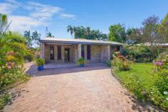  13 Copra Crescent Karama NT 0812 $450,000 Arriving at this home, you are greeted by the most glorious, lush, tropical gardens. Lovingly cared for, these well-established gardens are simply a joy to behold. You'll see an ample lawn to the front and the rear garden is vast making for a dream family enclave. With parking for 2 cars, step inside the cool of this solid brick home. Entering the bright living space, you will be struck by the high ceilings and immaculate order of this property. While there is potential to modernise this space, it is in move in condition and prepared to host family life. The open plan living and dining area adjoins the neat kitchen, all with views to the beautiful rear garden. The kitchen is perfectly positioned to oversee any smaller family member's activities, both indoor and out. From the living area, sliding doors lead to a peaceful verandah extending the length of the home. Great for dining or just relaxation and overlooking the stunning lawn. Stepping back inside, we visit the first of three bedrooms. This room with built in robe, ceiling fan and air-conditioning offers the perfect position to function as a work from home space or study. Bedroom two is similarly appointed and sits opposite the main family bathroom. While this bathroom boasts original features and a separate WC, you will see potential to add your personal touch here. The master suite is bright and airy, with generous proportions, built in robes and ensuite. The laundry is conveniently located next to the main bathroom and offers its own entrance to the garden, giving easy access to the paved drying area with Hills Hoist. Just moments from the Casuarina Shopping Hub and close to university and hospital, this original owner-occupied home is primed to become a much-loved family residence. 