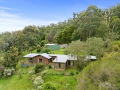  115 Denhams Road Hallston VIC 3953 Located approximately 15 minutes from the township of Leongatha, nestled amongst the rolling green hills and bushland of South Gippsland is this most unique home. A special gem here, built with rock from the earth, it is positioned so beautifully upon to take in the serenity of the native bushland, the tallest of gum trees, and an abundance of bird life. Beginning as a cottage and expanding over the years to create a much-loved family home, this rock, brick and cedar home has character and warmth. Situated on an undulating 32 acres (12.75 ha) a mix of bush surrounds 6 fenced paddocks with the beautiful 'Brookes Creek', meandering through the property. The home features: - Kitchen with gas cook top, double electric oven, breakfast bar and dining space - Cathedral ceilings extend into the formal dining room with a sunken lounge, featured rock walls and wood heater. - High ceilings throughout the home with expansive windows providing views into the treetops. - The spacious lounge room enjoys a second wood heater with gorgeous views across the property and opens out to the front entertainment deck. - A custom designed office doubles as a music sound room, a perfect work from home office - There are three bedrooms with the smaller having built in bookshelves, the second with built in robes and the master complete with ensuite and walk in robe. - The family bathroom has shower, vanity, and toilet with a third external toilet. - The laundry is an ideal mudroom with workspace, storage, and wash tub. - With two wood heaters, 2 reverse cycle air conditioners and ceiling fans, the home is cool or warm, all year round. Externally: - 12.75 HA / 32 ACRES (approx.) fenced with 6 internal paddocks. - The original stone-built studio with stained glass windows is bursting with options for the creative! - An excellent lock up machinery/workshop shed is fully concreted with power. - Assorted original timber and cedar buildings provide car parking and sundry shedding. - Excellent water storage plus access to the permanent Brookes Creek Located 15 minutes from the nearby towns of Leongatha and Mirboo North, 35 minutes to the pristine beaches of Inverloch and within 1.5 hours to Melbourne's Southeastern Suburbs. This point of difference, soulful property is truly something special and most worthy of your consideration. 