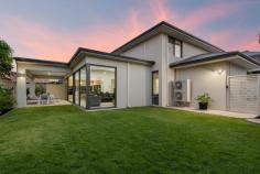  5A Park Road Mount Pleasant WA 6153 Completed in 2022 by renowned builder, Da Vinci Homes, this stunning family home is located in a whisper quiet location and positioned just one block to the riverfront foreshore in sought after Mount Pleasant. Positioned on 514sqm of prime Survey Strata land, this contemporary home with ground floor master bedroom is ideal for families or downsizers alike! With excellent natural light and high ceilings throughout, this home has been thoughtfully designed with an open plan and flexible layout ideal for modern day living! There is a large open plan kitchen, meals and dining area positioned towards the northern aspect of the house allowing for an abundance of light and green outlook to the rear yard. The kitchen has been well designed and includes a central island bench with statement pendant lighting and a leafy green outlook. There are also stone bench tops, double ovens, wide induction cooktop, double sink, room for a double door plumbed refrigerator and ample cabinetry and storage. Adjoining the kitchen you will find a scullery, ideal for use when entertaining guests, with integrated dishwasher, additional sink and generous walk-in-pantry. The master bedroom is positioned on the ground level making this home ideal for downsizers who want the option of single level living. The tasteful design includes a high recessed ceiling, sheer curtains and a walk-in-robe with custom cabinetry leading through to the ensuite bathroom. Complete with high end finishes, the ensuite includes full height tiling, walk in shower, double vanities and separate w/c. Downstairs you will also find a separate study, theatre room, laundry and powder room. Upstairs there is another central living area, with Blackbutt hardwood flooring, and three additional bedrooms. All double size bedrooms include built in robes and tasteful sheer curtains. There is also an additional bathroom featuring full height tiling, shower and bath as well as a separate w/c and linen cupboard with built in laundry chute. The rear yard of the property can be accessed off the main downstairs living area via large stacking doors which provides access onto the alfresco area with gas bayonet for mains barbeque connection. There is ample grass for kids to play and pets to roam which has been designed to allow room for the inclusion of a pool if desired. The front of the house includes an oversized double garage with storage area as well as space to store a boat or caravan if desired. Additional features of this home include mudroom at garage entry, under stairs storage, ducted reverse cycle air-conditioning throughout, shared bore with 5 Park Road dwelling, instantaneous gas hot water system, reticulated gardens and NBN connection. This convenient location is a short scenic stroll to parks and the riverfront foreshore, Deep Water Point, cafes, shops and Mount Pleasant Primary School. Nearby to Westfield Booragoon, easy access onto freeway north and south plus Applecross high school catchment and excellent private high school options close by being Penrhos College, Aquinas College, Wesley College, All Saints and Corpus Christi. 