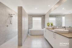  22 Moort Rise Carramar WA 6031 $1,150,000 WOW! This stunning 5-bedroom, 3-bathroom property can only be described as HUGE! Situated in the sought after ‘Wildwood Estate’ Carramar on a premium 1,539sqm block, this residence offers the space & quality that your family deserves. Features & benefits include: * Exposed aggregate driveway * Wide front verandah leading to double door entrance * Grand entry foyer with feature recessed ceiling * Huge master bedroom suite with French doors to outside, walk through fully fitted dressing room leading to deluxe ensuite with twin vanities, walk in shower, freestanding bath, floor to ceiling tiling & separate WC * Home theatre with double doors * Guest bedroom suite with ensuite * 3 further spacious bedrooms * Home office * Activity area * Open plan family & meals areas with electric effect fire * Stunning kitchen with engineered stone benchtops incorporating recessed sink, 3 ovens, dishwasher, 900mm gas cooktop, walk in pantry, double fridge recess * Scullery with stone benchtops, sink & further cabinets leading through to fitted laundry * Family bathroom with twin vanities, shower & bath * Powder room * Reverse cycle my zone air conditioning for year-round comfort * Vinyl plank flooring * Outdoor entertainment areas with polished concrete flooring * Extensive synthetic lawn for minimal maintenance * Children’s playground with inground trampoline * Full side drive though access providing plenty of parking for boat / caravan / cars & trailers * Double, remote garage * Built by Dale Alcock Homes * 392 sqm Under Main Roof * 332 sqm internal floor space excluding garage * Huge 1,539 m2 block 