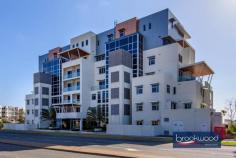  Unit 5/5 Reserve St Scarborough WA 6019 $825,000 Steps from the iconic Scarborough beach, this luxury second-floor apartment gazes out to the Indian Ocean, a symphony of changing colours and moods. High-spec finishes, including oak floors and Miele appliances, an open plan design that melds into a wide balcony overlooking the sea and a small complex with a communal pool, gym and sauna come together to deliver boutique living steps from the rejuvenated promenade and 15 kilometres from Perth CBD. 2 bedrooms 2 bathrooms 2nd-floor corner apartment Huge balcony ocean views Oak floors Miele appliances Pool gym and sauna onsite High ceilings double glazing Secure complex UC parking 2 bays Intercom system & CCTV security Oceanside boutique complex Winner 2015 MBA Award – Best built apartment building in WA Steps from the azure waters of Scarborough Beach and the vibrant array of restaurants, bars, and entertainment along the revitalised promenade, this sophisticated oceanside apartment epitomizes the quintessential indoor-outdoor lifestyle. Its open-plan living seamlessly extends to a spacious balcony, offering panoramic vistas of the Indian Ocean. Positioned on the second floor and occupying a coveted corner spot, the apartment employs lofty ceilings, expansive full-height windows, and a predominantly white palette to craft a refined living experience within a secure boutique complex. Oak flooring, sumptuous carpets and gleaming white stone surfaces accentuate the spectacular light of the coastal setting. The thoughtfully designed, impeccably appointed kitchen delivers ample inspiration for at-home, oceanside dining and entertaining with an electric oven, induction cooktop, dishwasher, ample storage and a sleek stone countertop. Tucked discreetly to the rear of the kitchen, a stylish European laundry adds to the convenience of modern living. Both bedrooms boast fitted built-in robes and soft carpet underfoot. The main bedroom boasts a fitted walk-in robe and modern ensuite with shower vanity and WC. The second bedroom has a built-in robe and accesses the family bathroom, a well-appointed space with shower, vanity and WC. Double glazing, ducted reverse cycle air conditioning, fobbed access, intercom and CCTV ensure exceptional comfort and convenience. Undercover parking for two cars, a storage unit, an on-site sauna, gym and pool add to this apartment’s long list of amenities and deliver the ultimate oceanside home. 