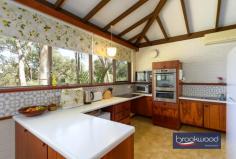  19 Cook St Darlington WA 6070 $779,000 Capturing the essence of 1970s design, this eye-catching family home showcases iconic features synonymous with the era – think exposed brick and beams, a raked ceiling and a floorplan revolving around a central atrium. The interior exudes warmth with its timeless timber built-ins and panels, complemented by the organic tones and texture of slate floors. This extraordinary home is now offered for sale for the first time in over five decades, presenting a unique opportunity to infuse new life and modernity. 3 bedrooms 2 bathrooms 1970’s built home Raked ceilings exp beams Extensive built-in storage Upstairs flexible living room Ducted vacuum system Powered work space + woodshed Paved drive double carport 2340 sqm elevated block Walk to Helena College Step through the grand double doors into a formal foyer, where slate flooring sets the tone for authentic 70s style. To one side, a generously proportioned living area beckons, while on the other, a formal dining room and a well-appointed kitchen await. The living room is an ode to relaxed sensibilities; it features a soaring raked ceiling adorned with exposed beams. Dual-aspect glazing fills the airy space with light and provides a view of the central atrium and the front garden. A slow-combustion fireplace and reverse-cycle air conditioning ensure year-round comfort, creating a harmonious blend of style and functionality. The formal dining room, with windows looking onto the atrium, leads into the kitchen and breakfast nook overlooking the front garden and surrounding natural landscape. The kitchen has electric appliances and boasts a large built-in pantry and split system air conditioning. A short flight of stairs leads from the living room to the main bedroom, a good-sized space looking onto the atrium with built-in storage and an ensuite with a shower, vanity and WC. The junior bedrooms, a study nook, and a family bathroom complete the bedroom zone layout. Both minor bedrooms have built-in storage and raked ceilings and benefit from a second slow-combustion fireplace. The flue of this second fireplace extends into the upstairs living area, a flexible area with multiple uses. The spacious second-storey extension with north-facing windows, built-in cabinets, and a wet bar is an ideal family room, guest accommodation, or teens’ retreat. It is not impossible to see this space transformed into an indulgent parents’ retreat with enviable tree-top views. Access to the under stairs wine cellar located on the exterior of the home, adds to the charm and a great use of space with built in wine bottle holders. The home is paved on all sides with a courtyard area to the southern side where you can settle in and enjoy the afternoon glow of the sun setting through the trees. A small, powered workspace sits at the top of the block. A space where your ideas and hobbies can come to life. Such a versatile area or can purely be used for extra storage and gardening tools. A woodshed located to the side with a lean-to roof, designed to keep yourself and the wood dry through the winter months. This move-in-ready property presents a canvas of possibilities with a coveted Darlington address, original features and a flexible floorplan, extending an invitation to reimagine the home’s potential. To those with a discerning eye, the intact seventies features offer a springboard to create a truly striking Hills home. Seize the moment to embark on a journey of renewal, establish a presence in this highly sought-after locale and embrace contemporary living in a fusion of iconic design and modernity. 