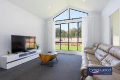  1645 Woodlands Rd Stoneville WA 6081 $1,329,000Located in the family friendly Hills neighbourhood of Stoneville, 1645 Woodlands Road is a spot of executive luxury in a quiet natural location. Expansive, contemporary and sleek, this 2021-built Dale Alcock 4 bed 2 bath home is ideal for someone wanting the balance between modern stylish living and a usable easy-care block perfectly positioned for hobby farming or equestrian activities. 4 bedroom, 2 bathroom 2021-built Brick & Iron Modern chef’s kitchen Butlers pantry/storage Stylish open plan living Study and theatre room RC ducted app-control A/C Paddocks, easy care gardens 200 sqm powered workshop Ablutions/office/bar/storage 5.07-acre level fenced block Entering the home – with soaring vaulted cathedral ceilings, panoramic A-frame windows and light, neutral décor – we are greeted with a picture of contemporary brightness. Set adjacent to the wide foyer, we find the centres of business and pleasure respectively – a cosy yet functional study with plenty of natural light and space for shelving and a bright home theatre room, fitted with A-frame windows and light, dreamy drapes. The beating heart of this beautiful home lies in the modern, stylish chef’s kitchen replete with sleek cabinetry, stainless steel appliances, a walk-in butlers pantry and with a dedicated mud room, storage is a breeze. A gleaming Caesar stone quartz benchtop, warmly toned flooring and steel feature beams both capture the natural elements and crisp clean lines of the open plan living area. The outdoor alfresco is perfectly positioned for indoor/outdoor entertaining, with wide sliding doors leading directly from the kitchen and framed by a coffee rock wall and a shallow oasis of lush green lawn. Manicured to perfection, this grassy area is the perfect spot for children or animals to play safely. The master bedroom is a modern sanctuary – a vast clean space with wide vista views to the fields beyond, soft carpet underfoot and a decadent walk-in dressing room. The master seamlessly blends to the ensuite bathroom, which is decked out with luxurious finishes including a double vanity, a walk-in rain shower and freestanding bathtub. The junior south facing wing features three large bedrooms all with built in robes, a family bathroom with bath, shower, vanity, a separate powder room and a dedicated activity room- a relaxing chillout space for teenagers with plenty of space for games and toys. Located behind the main residence lies a huge 200 sqm powered workshop with extra height rolling doors, concrete flooring, an enclosed office space and ablution area fitted with shower, WC and vanity. This shed is truly the handy man’s dream. This home is full of high-tech easy living features; a shoppers entry from the double garage, LED energy efficient lighting, a Daikin reverse-cycle ducted air conditioning system and smart wiring all add to modern appeal. This 5.07-acre property has great potential for self-sufficiency and is perfect for animal or agriculture lovers, with several enclosed paddocks with gated access ways and a 150,000 litre rainwater tank – ideally positioned for a hobby farm or an expansive productive garden. Site works have been started that can easily be converted to an equestrian arena or the potential pad for a studio/granny flat, (due diligence from the Shire). Set in Kanangra Estate, a prestigious neighbourhood of quality homes, the property is in a convenient location with easy access to local schools, the bustling village of Mundaring with arterial road links offering rural living without compromise. 