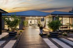  11 Dunnett Avenue North Rothbury NSW 2335 $885,000-$940,000 Are you looking for luxury, quality and size with easy-care landscaped gardens? This stunning home is move-in ready and centrally located in Huntlee Estate, one of the most sought-after estates in the Hunter Valley. Only minutes to the Hunter expressway, Huntlee Tavern, Coles, Chemist, childcare centre, dog park, a massive playground, and a short drive to the world-renowned Hunter Valley wine country, there is no better place to call home. It was built by Sekisui. and was originally a display home. Immaculately presented, this home will suit the fussiest of buyers and has everything you can dream of throughout this sizable haven. As you step inside, you are greeted by a wide hallway leading to the centre of the home with downlights, ducted air conditioning and ceiling fans, ensuring an air of luxury and sophistication. Floor-to-ceiling windows are covered with elegant drapes or plantation shutters. Multiple spacious living and entertainment areas allow guests and family to spread out and enjoy their own privacy. A purpose-built study with built-in desks gives you room to work from home. The children can have their own rumpus/activity area, set well away from the main living; there is ample space for the whole family to relax. A spacious, contemporary kitchen features an expansive Butler's pantry, stainless steel appliances, a stunning 40mm stone benchtop with waterfall edging, a large breakfast bar, and ample storage space for all your culinary needs. There is loads of room for the chef of the family to cook up a storm! Four generously sized bedrooms are well-appointed, featuring built-in robes, plush carpet, and large windows. The grand master suite stands independently and has been luxuriously designed with a well-sized, walk-in robe fully fitted with drawers and hanging, a spacious ensuite and floor-to-ceiling windows. It is situated at the rear of the home and is perfect for shift workers. Glass sliding doors seamlessly connect indoor with outdoor living; upon stepping outside, you will notice the impressive outdoor alfresco and expansive decking area fitted with ceiling fans for a breeze through summer and retractable alfresco blinds to protect from unwelcome weather. The backyard also boasts various seating areas ideal for entertaining or relaxing with total privacy. Tastefully designed, the garden offers a peaceful tranquillity, with a "Zen" feeling and easy care maintenance. There is no mowing needed. And yet, there is enough room to install a pool if you wish. The garage offers loads of space for large cars. It also has access via a glass sliding door into a 3rd bay suitable for use as an office, extra storage or workshop. All of the garage floor has epoxy coating, making it easy to keep clean if you have a spillage or oil leaks. A 10 KW solar power system with 31 panels saves you money with minimal electricity bills. This is a must-see home to appreciate the size and quality truly 