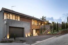  2A The Spur Frankston South VIC 3199 $1,250,000 - $1,375,000 Presenting an alluring lifestyle of exclusivity and coastal elegance, this renovated beachside home effortlessly blends timeless charm with contemporary sophistication. Nestled amidst a picturesque back-drop of lush greenery, a lofty elevation and modern facade forms a bold street presence to this five-bedroom FHSZ home. Delighted by a north-facing light, the dual-storey design delivers families a firm entertaining footprint where everyday living holds focus across a first-floor domain. Alluring with white-washed timber beams and a clean neutral palette, the light-filled level anchors accommodation with an open plan lounge and dining space, and kitchen complete with servery window, stone benchtops and premium-grade appliances. Making use of its elevation sees a private treetop alfresco extend entertaining outwards, while an intimate space for the children remains to the rear with direct Frankston Jamboree Park access. A dreamy master bedroom provides luxury for parents, with a dressing room and stylish ensuite, custom sheers and north-facing orientation. Servicing both family and guests, a main bathroom with stone-topped vanity sits central to three additional bedrooms across the top floor. The glimmer of a gas fireplace warms the downstairs level, where a generous lounge with wet bar, updated main bathroom and fifth bedroom with private alfresco access inspires a guest/teenager retreat, or the potential for short-stay accommodation (SCTA). With reverse-cycle ducted heating and cooling, solid timber floors, custom window furnishings, alarm system, a single garage and architecturally-designed gardens by Colin Hyett Design, this contemporary home sits only moments from Frankston Foreshore and Boat Ramp, Frankston High and Overport Primary School, and Bayside Shopping Centre. 