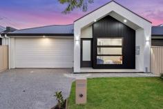  1 Dingera Ave North Plympton SA 5037 $880,000-$960,000 With a striking gabled north-facing facade, this brand new Torrens Titled home is built with class and convenience at its forefront. Herringbone floors line the entry hallway, where an accessible plushly carpeted master bedroom at the front of the home reaps the rewards of its northerly-aspect with abundant natural light, as well as the comforts of a walk-through robe and luxurious ensuite bathroom with full-height large format tiling and shower with wall niche and rainfall showerhead. An additional two bedrooms each enjoy mirrored robes and are serviced by an equally impressive central main bathroom with deluxe fittings, inset bath and roomy shower. Overlooking a spacious living and dining space with bulkhead, the sleekest of galley-style kitchens offers a gas cooktop, subway-tiled splashback, double sink, dishwasher and breakfast bar with waterfall benchtop to kitchen creatives, as well as plenty of overhead storage space and decorative pendant lighting. Sliding doors reveal a secure, minimal-maintenance alfresco with open timber pergola and lawn strip. The finer points: - Ducted reverse cycle air conditioning - Spacious double garage with laundry facilities + side & internal access - Off-street driveway parking - Linen storage - Landscaped front garden Let's talk location. Central to city and sea, the neighbouring Weigall Oval Reserve and Westside Bikeway will provide endless respite for restless legs within walking distance; the tram, bus, local shops and cafes, the Highway Hotel and schooling options for all ages all within a kilometre radius. It's contemporary, clean-lined convenience at its finest. Brand new looks good on you. 