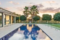  75 Bankers Road Bywong NSW 2621 Exquisitely designed and positioned to capture the northern sun, this grand family abode beckons those in search of perfection. With a secluded location, the expansive residence is ideal for large families, car enthusiasts (9 car garage!) or those seeking versatile living arrangements for extended family. Either way, 75 Bankers Road makes a powerful statement in style and sophistication with a heavy emphasis placed on indoor and outdoor entertaining and resort-style living. From the moment you step through the front door, your eyes are draw to the picturesque backdrop of the sparkling in-ground swimming pool and verdant grounds. A clever design encompasses formal and informal living areas, separate tv room and music/rumpus room, library and study. For the chef in the family there is the show stopping fully equipped entertainer's kitchen, complete with integrated Miele appliances and walk-in butler's pantry. It is the perfect place to cook up a storm and still be connected to family and friends. A segregated parent's retreat boasts a walk through robe, indulgent ensuite complete with spa bath and a private elevated terrace, the perfect spot to end the day. The secondary bedrooms offer a flexibility that is rarely found with a guest bedroom featuring its own ensuite, built-in robes to all rooms and the office/5th bedroom also with its own walk-in robe and ensuite access to a bathroom. Surrounded by beautifully landscaped gardens, you will find a prolific fruit tree orchard, vegetables gardens and manicured lawns spread across 1.18ha. Located in Hideaway Estate, you have exclusive access to an additional 37.12ha of community land, ideal for exploring on foot to find that perfect picnic spot, birdwatch or be one with the natural bush. Situated just over 18 minutes to Dickson, 7 minutes to Sutton Village and 14 minutes to Bungendore the commute is short. School buses depart from the entry to Bankers Road to Canberra's major schools, and Coles and Woolies home deliver giving you all the benefits of rural living without compromise. 75 Bankers Road is an outstanding example of rural living at its best with all of the hard work done. North facing solar passive home Expansive family residence on 1.18ha In slab electric heating to parents retreat and kitchen and family room Reverse cycle air-conditioning throughout Slow combustion fireplace in family room Double glazed argon filled windows Porcelain tiles in living area, spotted gum timber floors in entry and formal lounge dining An abundance of storage throughout Ducted vacuum Mudroom entries from garages Under house wine cellar 18m x 4m tiled lap pool with 2 separate lanes 20KW solar panels on roof 3 phase power Alarm system 100,000L water tank Bore water connected to garden taps 2 bore water community water tanks Manicured gardens around residence Orchard and vegetable gardens Formal gated entry to property - with beautifully designed Corten inserts Council Rates: $1,648pa (approx.) Community Fees: $1,800pa (approx.) 