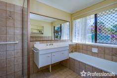  18 Magnetic Drive Tamborine Mountain QLD 4272 $1,050,000 Perched proudly on the hill, this solid home offers impressive views of the Gold Coast and the ocean beyond from the main living areas and the sunny north-facing covered deck. Built in the 1980s, this two-storey brick home exudes durability and charm, reflecting the era when homes were built to last. Although it may need some updating, it remains comfortable and well-maintained, making it an excellent investment opportunity or enjoy as your family home. The home features a bright and airy interior, with abundant windows throughout to capture the breeze. Upon entering through the formal entrance hall via the front veranda, you are greeted by a formal lounge and dining room with views of the coast. The practical kitchen, equipped with electric cooking, offers south-facing views from the window, and the adjacent family dining area opens to the BBQ deck. External door and ramp to the back garden adds convenience. Downstairs, a self-contained living space offers additional flexibility with a bedroom, lounge, kitchenette, and bathroom. This area is ideal for extended family, guests, or potential rental income. Additionally, a “mancave” workshop or dry storage space provides extra room for hobbies or storage needs. Main level: – 3 bedrooms – Family bathroom – Laundry – Separate living room – Dining room – Kitchen – Front and rear deck Downstairs: – 1 bedroom – Family room – Kitchenette – Bathroom Underneath: – Workshop/man cave, dry storage Outside: – Carport – Flat 1,012m2 block – 8 solar panels The very neat mature gardens offer ample space for children to play or for growing vegetables. With two driveways, one leading to the granny flat and one to the upstairs level, and a single carport with room for a garage if desired, this home combines practicality with potential. 