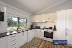  20 Cottage Ct Bakers Hill WA 6562 $795,000 Nestled on a picturesque 2.16-hectare (5 acre) block at the end of a tranquil cul-de-sac, this immaculate steel frame and Colorbond four-bedroom home, offers a blend of modern living and country lifestyle. Immaculate 4 bedroom home Picturesque 2.16-ha block Spacious open-plan living High cathedral ceils, mod finishes Large master bedroom Queen-sized secondary bedrooms Huge modern bathroom Expansive 3m-wide wrap-around verandah Large, powered shed with hardstand Plus small garden shed Connected to scheme water, 3-phs power Includes several paddocks Tranquil location, quiet cul-de-sac Stunning valley outlook Built in 2012, the home features a country, practical design with approximately 200 sqm of internal living space. The spacious open-plan layout encompasses a kitchen, meals area, family room plus study nook – providing an inviting atmosphere for family gatherings and entertaining. With sleek finishes, the main living area is enhanced by a woodfire heater and reverse cycle air conditioning, ensuring comfort throughout the year. Scheme water is connected, so no tanks are required. All four bedrooms are generously sized – each equipped with ceiling fans, while the master bedroom boasts extra space for relaxation. The very large modern bathroom features integrated laundry facilities, complemented by a convenient powder room. Outside, the home is surrounded by a stunning 3-meter-wide wrap-around verandah that invites you to enjoy the beautiful views and expansive lawn. Additional features include a double carport under the main roof, a small garden shed and a large, powered shed with a concrete pad, perfect for hobbies or storage. This lifestyle property has a 90sqm shed which includes a self-contained studio (ideal for visitors) plus substantial hardstand area. The shed was lived in whilst the house was being built. The property is well-equipped with several paddocks, good fencing, feed shed and a Colorbond horse float shelter. With all the hard work done, you can relax on the wide back verandah with friends, whilst enjoying the valley outlook with a northerly aspect. Don’t miss your chance to secure this beautiful property. 