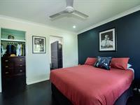  20 Fitzpatrick Street WALKERSTON QLD 4751 $499,000 Welcome to a residence that effortlessly blends style, elegance, and comfortable living amidst the lush tropical setting of Walkerston's semi-rural charm. This is more than just a home; it's a haven where you can relish peace and serenity without the hassles of high maintenance. Crafted with a meticulous eye for detail and a seamless indoor/outdoor lifestyle in mind, this exquisite property boasts top-notch fittings and finishes that elevate your living experience. Key Features: 1. Three Luxurious Air-Conditioned Bedrooms: The master bedroom features an enviable ensuite and a spacious walk-in robe 2. Sleek Designer Kitchen: A stylish, modern kitchen equipped with high-quality appliances awaits the culinary enthusiast in you 3. Open-Plan Living: The open-plan indoor living area effortlessly extends to a rear entertaining deck, creating a harmonious flow between spaces 4. Custom Outdoor Kitchen: Enjoy alfresco dining in style with a custom outdoor kitchen, surrounded by serene gardens 5. Double Lock-Up Garage: Your vehicles will find shelter and security in the spacious double garage 6. Impressive Corner Block: This 551sqm corner block residence boasts an impressive street presence, setting it apart 7. Solar Panels: Embrace eco-friendly living with the added benefit of solar panels Nestled in the heart of Walkerston, this location offers the best of both worlds-rural tranquility with city conveniences just a stone's throw away. You'll find supermarkets, schools, medical facilities, sporting clubs, and hotels, all within easy reach. Don't miss the chance to make this tropical oasis your own. 