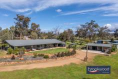  20 Cottage Ct Bakers Hill WA 6562 $795,000 Nestled on a picturesque 2.16-hectare (5 acre) block at the end of a tranquil cul-de-sac, this immaculate steel frame and Colorbond four-bedroom home, offers a blend of modern living and country lifestyle. Immaculate 4 bedroom home Picturesque 2.16-ha block Spacious open-plan living High cathedral ceils, mod finishes Large master bedroom Queen-sized secondary bedrooms Huge modern bathroom Expansive 3m-wide wrap-around verandah Large, powered shed with hardstand Plus small garden shed Connected to scheme water, 3-phs power Includes several paddocks Tranquil location, quiet cul-de-sac Stunning valley outlook Built in 2012, the home features a country, practical design with approximately 200 sqm of internal living space. The spacious open-plan layout encompasses a kitchen, meals area, family room plus study nook – providing an inviting atmosphere for family gatherings and entertaining. With sleek finishes, the main living area is enhanced by a woodfire heater and reverse cycle air conditioning, ensuring comfort throughout the year. Scheme water is connected, so no tanks are required. All four bedrooms are generously sized – each equipped with ceiling fans, while the master bedroom boasts extra space for relaxation. The very large modern bathroom features integrated laundry facilities, complemented by a convenient powder room. Outside, the home is surrounded by a stunning 3-meter-wide wrap-around verandah that invites you to enjoy the beautiful views and expansive lawn. Additional features include a double carport under the main roof, a small garden shed and a large, powered shed with a concrete pad, perfect for hobbies or storage. This lifestyle property has a 90sqm shed which includes a self-contained studio (ideal for visitors) plus substantial hardstand area. The shed was lived in whilst the house was being built. The property is well-equipped with several paddocks, good fencing, feed shed and a Colorbond horse float shelter. With all the hard work done, you can relax on the wide back verandah with friends, whilst enjoying the valley outlook with a northerly aspect. Don’t miss your chance to secure this beautiful property. 