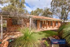  21 Truslove St Wooroloo WA 6558 $579,000 Nestled in a picturesque Hills setting, this completely renovated home is a delight to behold. Encircled by a small patch of new turf, native mulched gardens, and tranquil rural views, a comprehensive renovation has transformed this property into a modern, low maintenance sanctuary on the outskirts of Wooroloo. 3 beds 1 bath plus study 1994-built brick and tile Fully renovated Hills home New flooring & fresh paint New kitchen appliances Soft-close drawers cabinets Split system air conditioning New reticulated gardens 2200 sqm block valley views Rural living with city style Fresh paint, plush new carpets, new vinyl flooring, and new window treatments fashion a bright and welcoming first impression as you enter the lounge room through the front door. Large windows frame the sculptural forms of grass trees dotted throughout the garden, and a split system air conditioner brings year-round comfort to the central living zone. This spacious, carpeted room has ample room to be used as a multifunctional area, for a formal dining area or cosy reading nook with a set of built-in shelves at one end. The fully renovated modern kitchen sits behind the lounge and boasts a crisp white palette, timber laminate benchtops, all-new electric appliances, and soft-close drawers and cabinets. An informal meals area arranged to one side of the kitchen opens to a paved verandah and small lawn area via a sliding glass door. The modern vibe continues to the fully renovated laundry with overhead cabinets and a built-in wash trough, offering a practical and functional layout. The contemporary bathroom is a beacon of understated chic with a free-standing modern tub, timber-topped vanity with above counter basin and shower bringing a dose of style and a limited palette of colours ensuring a sense of calm. A generous main bedroom is situated at one end of the plan. What was originally a carport has been transformed into a stylish and comfortable space with dual-aspect glazing, new carpets, and new window dressings. An open space adjoining the main bedroom makes an ideal nursery or study. Both junior bedrooms feature new carpet, paint, and blinds, and one boasts split-system air conditioning and both with built in robes. The renewal and renovation evident across the interiors of this property continue outside with new paving, gutters, downpipes and freshly mulched reticulated gardens. With all the work done, this is a truly move-in-ready home. Wooroloo is a quintessential Hills town with a small general store and easy access to road links to Mundaring and beyond; it sits nestled in the unending beauty of a natural Australian landscape. 