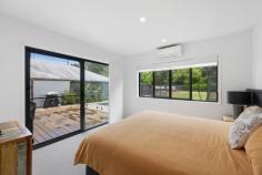  9 Nature Place Buderim QLD 4556 Located in the heart of Buderim, this modern designer home offers a perfect blend of style and convenience, close to top schools and essential amenities. Experience contemporary living with an open plan design that seamlessly connects the kitchen, dining, and living areas. High ceilings enhance the space with natural light, creating an inviting atmosphere ideal for both relaxation and entertaining. The kitchen is a culinary dream, featuring premium appliances, gas cooking, a well-appointed butler's pantry, and sleek matte black finishes. An additional media room provides versatile space for various needs. The master bedroom is a retreat with its ensuite, twin vanity, and walk-in robes. Three more bedrooms offer ample storage and split system air conditioning for personalised comfort. A double garage with side access and extra space for a trailer or camper van simplifies parking. The expansive yard boasts an entertaining deck overlooking the pool and a lush reserve backdrop. With stylish, high-quality finishes throughout, this home delivers luxurious living and modern functionality! 