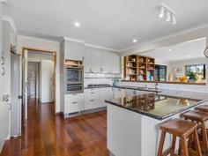  8 Old Waratah Rd Fish Creek VIC 3959 $885,000 Sitting proudly on approx. 1843m2 of land, capturing a rural feel with easy access to everything this popular township has to offer, this upsized property will appeal to anyone looking for space without sacrificing convenience. Inside is light and bright with a wide entertaining deck on two sides providing just the spot to sit and take in the views over the farmland at the rear and to the distant hills beyond the town. The open plan interior is zoned to provide a living room, dining room and lounge area - comfortable all year round with a wood heater plus ducted RC/AC. Centrally located, the stylish modern kitchen includes a huge breakfast bar, wall oven, gas hob, dishwasher, extensive storage including a butlers pantry and utility / storage area. There are five fitted bedrooms including a large master suite with walk in robe and spacious ensuite. Ducted reverse cycle heating and cooling to each of the bedrooms for year round comfort. Modern main family bathroom with spa bath, shower and separate w.c. A central roofed deck includes covered access to the downstairs garage / workshop / studio / games room and under-house storage. The rear garden is fenced and secure with access from Farrell Lane and includes an established vegetable garden. Keep your costs to a minimum with solar power (plus mains) and solar hot water (electric back up). Come and discover the delights of this quirky village with galleries, cafes, award winning Hotel, the Great Southern Rail Trail, community garden and primary school all on your doorstep, and only 15 minutes from the pristine coastline for swimming, surfing and hiking. 