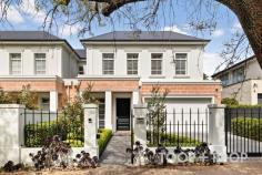  18 Myall Ave Kensington Gardens SA 5068 Custom designed and built to an exacting standard by Billy Diamantis of Kudos Constructions, this sensational residence is perfectly positioned in the peaceful tree-studded heart of one of the east’s most desirable and convenient dress-circle enclaves. An outstanding home with flexible living and entertaining options suitable for a range of discerning buyers, its beautifully designed floorplan offers space, versatility, security, and a sophisticated timeless aesthetic of understated luxury. The exceptional quality of construction is obvious from the outset. With a commanding street presence, the gracious frontage presents a modern take on classical Georgian architecture and proportion that incorporates a soaring portico entrance and remote entry double garage with secure internal access. A large and versatile reception room introduces stunning American oak floors, high ceilings and custom designed architraves. A wide gallery-like hallway stretches towards open plan living past a glass doored wine room, family laundry with north facing drying yard, and a glamorous powder room. The sumptuous master suite is conveniently located on the ground floor and includes a walk-in robe and designer bathroom with double vanities and walk-in shower. A glass slider bathes the bedroom with light and opens to a delightful internal paved courtyard. Upstairs accommodation is perfect for the family, with three bedrooms, all with built-in robes, a huge bathroom with bath, and another large living retreat. Expansive open plan living to the rear is the jewel in the crown, forming the ultimate light-filled space in which to entertain on a large scale or enjoy cosy nights in around the instant gas fire. The no expense spared gourmet kitchen incorporates extensive custom joinery, a range of fully integrated European appliances, and an engineered stone island bench around which to gather. Sliders expand indoor living through to alfresco living and the glorious rear garden. The dining pavilion is equipped with a built-in kitchen with Beefeater BBQ and rangehood, with a paved area providing an extended entertaining area. Gently elevated, a large lawn is edged by Japanese box and ornamental pears, which forms a private and tranquil haven teaming with birdlife The enviable family friendly lifestyle location of this property is very special. Surrounded by some of Adelaide’s leading schools, it’s a short stroll to magnificent recreational reserves, and close to Norwood Parade, Kensington Road, Leabrook, Erindale and Burnside shopping and restaurant precincts. This outstanding home is perfect for those seeking a peaceful and private property with all the prestige and convenience this highly coveted location has to offer. FEATURES YOU WILL LOVE • Custom designed & built in 2020 by Billy Diamantis & Kudos Constructions • Remote gate entry • Remote entry double garage with epoxy floor • Pedestrian gate intercom • Additional driveway parking • Ducted R/C air conditioning • Instant gas fire • Ceiling fans • 2 x Smeg ovens, gas cooktop & integrated dishwasher • Integrated Fisher & Paykel fridge/freezer • Butler’s pantry with room for second fridge • Outdoor kitchen with Beef Eater BBQ & rangehood • Wine room with racking & additional under stair storage • American Oak flooring • Extensive storage • Built-in robes • Alarm • NBN connected • Plantation shutters • Automated outdoor blinds • Automatic irrigation • Utility area LOCATION: Less than 8km to Victoria Square LIFESTYLE: Stroll to Kensington Oval and Kensington Gardens Reserve with ovals and tennis courts. Close to Norwood Parade, Kensington Road, Leabrook, Erindale and Burnside shopping and restaurant precincts SCHOOLS: Zoned to Magill Primary School and Norwood International. Walk to Pembroke. Close to St Peters Girls, Loreto, St Ignatius Junior School 