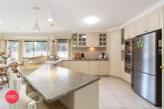  2 Eyre Street Bungendore NSW 2621 $1,175,000 - $1,225,000 If your wish list for a new property includes a heated inground pool, extra shedding, a large 5 bedroom ensuite plus rumpus home and stunning gardens on over 1200 sqm, your search will hopefully end at this property. Ideally located at the end of a quiet street, you will find this much loved family home with great street appeal. Immaculately presented and fastidiously maintained, this property is a credit to the owners who have had it since new. The family friendly floorplan will easily cater for large families without a problem. The layout includes a segregated master suite at the front, a large centrally located kitchen, 3 spacious living zones, 4 other bedrooms with built in robes, 3 way bathroom and large laundry. Supplementing the 3 generous living zones, the owners have converted the garaging under the roofline to a great games room for the pool table however it can still be used as garaging if required. They have been able to do this as there is additional garaging with side access which provides accommodation for 2 vehicles with plenty of room left for storage and workshop requirements. Year round comfort is assured with a combination of ducted gas heating and a large centrally located cooling system. An 8 kw solar system will certainly provide some relief from those nasty power bills which is always a bonus. For those who love to entertain, just imagine the options here. A beautiful solar heated inground salt water pool will provide endless hours of fun throughout the summer months and really gives this property that resort style feel. A covered outdoor entertainment area flows seamlessly from inside and is an entertainers delight. To complete this amazing package there are also fruit trees, raised vegetable gardens, greenhouse and much more. Be quick to avoid disappointment as this is a standout property. 