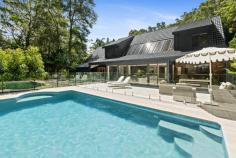  51 Pleasant Valley Rd Fountaindale NSW 2258 Nestled within an exclusive and private enclave, this breathtaking acreage retreat offers an unparalleled blend of space, sophistication, and resort-style living. Thoughtfully designed to embrace its natural surroundings, the residence seamlessly integrates grand interiors with lush outdoor spaces, creating a home that is both inviting and inspiring. Beyond the charming entryway, striking apex ceilings and expansive skylights flood the interiors with natural light, accentuating the warmth of timber finishes and the home’s architectural character. Multiple living zones provide flexibility for relaxation and entertaining, while the heart of the home—an elegant gourmet kitchen—boasts premium appliances and seamless indoor-outdoor connectivity. The upper level is dedicated to family living, featuring four oversized bedrooms, each with built-in wardrobes, including a master suite complete with a walk-in robe and private ensuite. A secondary sitting area enhances the sense of openness, overlooking the lower level and complementing the home’s fluid design. Outdoors, a private resort-style oasis awaits. A sparkling pool and expansive alfresco area offer the perfect setting for hosting guests, while a dedicated firepit zone provides an intimate space for cosy gatherings under the stars. Features include: – Architecturally designed with soaring apex ceilings, skylights, and expansive glass panels for abundant natural light. – Open-plan lounge, dining, and family zones, seamlessly flowing to the outdoor entertaining area. – Gourmet kitchen featuring a Smeg six-burner gas cooktop and oven, stone benchtops, ample cabinetry, and a breakfast bar. – A cosy living room with a wood-burning fireplace, perfect for cooler months. – An additional family room/home office, with French doors opening to the landscaped gardens. – Convenient downstairs bathroom + laundry with direct outdoor access. – Four oversized bedrooms on the upper level, all with built-in wardrobes. The luxurious master suite includes a walk-in robe and private ensuite. – A secondary sitting area upstairs, overlooking the lower level, enhancing the home’s sense of openness and connection. – An upstairs bathroom servicing the bedrooms, featuring a bathtub and sleek contemporary finishes. – Resort-style pool with glass fencing, surrounded by tropical landscaping and a sun-drenched alfresco zone. – Beautifully manicured lawns, a dedicated firepit area, and lush natural surrounds. – Double garage with internal access, plus additional driveway parking. – Additional features: fully fenced section for pets, under-house storage, ducted and zoned air conditioning, high ceilings, town water connection, and NBN. – Only 10 minutes to Tuggerah shopping precinct and train station + 12 km (approx. 15 minutes) to Shelly Beach. – Easy 8-minute access to the M1 Motorway for seamless travel to Sydney or Newcastle. – Council rates: $3,161 (approx.) pa. Offering the perfect blend of privacy, space, and contemporary comfort, this stunning acreage retreat presents a rare opportunity to embrace a lifestyle of tranquillity and modern luxury. While immersed in nature, it remains within easy reach of essential amenities, striking the perfect balance between rural seclusion and everyday convenience. 