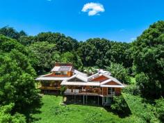  425 Friday Hut Rd Possum Creek NSW 2479 $2,900,000Now is the time to seize your dream of an idyllic life and make it a reality, rarely are acres like this offered for sale in highly sought after Possum Creek, a perfect setting just minutes from Bangalow and a short drive to Byron Bay. This 15 acre property affords privacy, peace and tranquility in a private setting overlooking arable paddocks fronting the Wilson River. The original owners of this four bedroom timber home have been there for nearly 50 years and reluctantly present their much loved property for sale. The red cedar home is nestled on hilltop cleared acres with elevated views to the Nightcap Ranges, the pristine waterway and riparian forest below. It offers four bedrooms, two bathrooms, a snug lounge, kitchen and open plan living area plus a second living space. There is a magnificent deck of grand proportion connecting the two wings of the home forming the true hub and heart of the home. Timber verandahs frame the views, an open fireplace creates warmth and security, timber polished floors and timber panelling define character and charm and raked ceilings enhance the country homestead feel. For the horse enthusiast you need look no further. The property offers covered yards, stable, tackroom and numerous shed and storage facilities. Established trees and gardens surround the home which is well protected and private from Friday Hut Road.. There are gentle paddocks with ample shade trees and water can be pumped from the Wilsons River. This is a home full of potential in an iconic location offering privacy, proximity and peace. Dreams do come true so seize the day! 