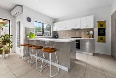  1/428 McClelland Drive Langwarrin VIC 3910 $699,000 - $749,000 Stacked with high-end finishes, clever storage, and a layout that just makes sense, this modern 3-bedroom townhouse delivers a home that's sleek, stylish, and straight-up effortless. A smart and effortless design that works for living easily has been crafted for maximum flow between indoors and out, ready for lively entertaining, kicking back, or just living your best life. Its open-plan living and dining zone is finished with large-format tiles and equally impressive natural light, filtering golden rays inside while peering out over its covered terrace and yard. The kitchen is a showstopper with warming tones and sleek stone benchtops surrounding stainless steel appliances, stepping outside to a private covered patio ready for morning coffees, sunset drinks, or lazing away. Three generous bedrooms include a downstairs master with a full ensuite and walk-through robe, with individual split-system comforts, a central bathroom and a separate toilet serving the upper level. Comfort is covered year-round with central heating and split-system air conditioning, while the remote double garage stores the wheels. Its location is near-unbeatable, just minutes from Karingal Hub, Mornington Peninsula Freeway, Karingal Heights Primary, McClelland College, and public transport, putting everything you need right at your fingertips. Whether you're a first-home buyer, a savvy investor, or looking to downsize without compromise, this one ticks every single box.  