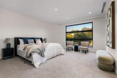  1/18 Broughton Road Surrey Hills VIC 3127 $2,000,000-$2,200,000 Welcome to 1/18 Broughton Road, a beautifully designed townhouse that perfectly blends modern architecture with urban living. This exquisite property offers a luxurious lifestyle with its spacious interiors, stylish finishes, and an unbeatable location in the heart of Surrey Hills. Property Features: - Bedrooms: 4 generously sized bedrooms, each designed with comfort and style in mind. The master suite features an elegant chandelier and ample natural light, creating a serene retreat. - Bathrooms: 3 modern bathrooms equipped with high-end fixtures, ensuring a spa-like experience at home. Enjoy the convenience and luxury of well-appointed spaces for relaxation. - Garage: Double garage spaces provide secure parking and additional storage, a rare find in urban settings. - Living Spaces: The open-plan living and dining area is perfect for entertaining, featuring stunning flooring and an inviting ambiance. The living room, adorned with tasteful decor and a cozy coffee table, flows seamlessly into the dining area, making it ideal for gatherings with family and friends. - Kitchen: The gourmet kitchen boasts modern appliances, ample counter space, and stylish cabinetry, making it a chef's dream. Prepare meals while enjoying views of the beautifully landscaped lawn through large windows. - Outdoor Area: Step outside to your private porch and lush grass area, perfect for alfresco dining or enjoying a morning coffee surrounded by nature. - Interior Design: Every corner of this home is thoughtfully designed, from the foyer that welcomes you with warmth to the carefully selected furniture and decor that enhance the overall aesthetic. -Neighborhood: Located in a vibrant community, this townhouse is just moments away from local cafes, parks, and shopping, offering the perfect blend of convenience and tranquility. Enjoy the best of urban living while being surrounded by beautiful greenery. 