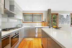  30 Killara Street Currumbin Waters QLD 4223 $1,790,000  Perched high among the gum trees with sweeping views over the iconic surf beaches of the Southern Gold Coast, this laidback yet luxurious treehouse retreat is truly a rare find. Set on an expansive 1969m² elevated block in a tightly held street, this north-facing family haven perfectly blends bushland serenity with coastal living. Just minutes from the world-renowned Currumbin Alley surf beach, it offers the ultimate lifestyle balance. Brimming with warmth and character, this light-filled, three-level home features four spacious bedrooms and two bathrooms — one showcasing a stunning freestanding bath with breathtaking ocean views. Timeless hardwood timber floors and bifold doors enhance the natural charm, while the open-plan design and seamless indoor-outdoor flow make it an entertainer's dream, perfect for gatherings in any season. A timber staircase leads to a private inground pool and covered poolside cabana, where you can relax and soak up the Gold Coast's famous sub-tropical climate. In summer, enjoy cool sea breezes from the expansive wraparound balcony, and in winter, unwind by the cozy wood-burning fireplace in the sunken living room — an ideal spot to curl up with a book or glass of wine. Although this home feels like a secluded hinterland oasis, it's just minutes from beautiful beaches, The Pines Elanora Shopping Centre, local schools, Currumbin Wildlife Sanctuary, and natural attractions such as Currumbin Rock Pools and Currumbin Creek. Property Features: Four bedrooms, two bathrooms, plus a powder room Spacious, custom-designed kitchen with island bench and stainless-steel appliances Polished hardwood timber flooring throughout Private inground pool surrounded by lush native gardens Expansive undercover wraparound balcony Cozy sunken living room with wood-burning fireplace Remote double lock-up garage Large internal laundry Multiple entertaining spaces Fully fenced front yard Prime location minutes to beaches, schools, shops, and natural attractions This stunning, one-of-a-kind sanctuary is being offered to the market for the first time — a unique opportunity to secure your very own slice of paradise and embrace the barefoot luxury lifestyle. 