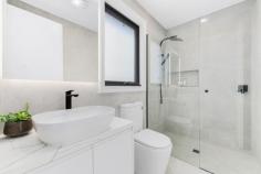  3/4 Medway Street Box Hill North VIC 3129 $1,600,000-$1,700,000 This brand-new dual-level townhouse is a meticulously designed, contemporary offering in one of Box Hill North's most sought-after locations. Just minutes from Box Hill Central's vibrant retail, dining and entertainment precinct, the home is also within walking distance of parks, childcare centres and local employment zones. Zoned for Kerrimuir Primary School and Box Hill High School, it's also perfectly positioned near public transport options. Designed with modern industrial inspiration, the home's striking facade combines textured brickwork with smooth render, creating a bold sophisticated aesthetic. The statement entryway, featuring a recessed porch and oversized timber door, offers a grand yet understated welcome. The black panel-lift garage door integrates into the design. Stunning 2.7m square-set ceilings enhance the sense of space, while opulent herringbone timber flooring flows throughout. The open-plan design is filled with natural light and large black-trimmed glass sliding doors open to a private courtyard. A centrally controlled zoned heating and cooling system ensures year-round comfort, while modern LED downlights illuminate. The ground-floor guest bedroom is a retreat, complete with a study and private ensuite. An external storage shed adds practicality. The decadent kitchen blends industrial chic with refined luxury. A four-seater breakfast island with 60mm marble-look stone, waterfall edging and feature v-panel backboards sits beneath striking black pendant lights. The splashback matches the stone benchtops while a matte-black double bowl sink with a gooseneck flick mixer is sophisticated. Finger-pull gloss white cabinetry and drawers provide storage, while quality 600mm appliances, including a gas burner cooktop, oven and dishwasher, cater to the needs of modern living. A spacious butler's pantry extends the kitchen's functionality, offering additional stone countertops, an extra sink and a second stove. Upstairs, three oversized bedrooms branch off a sunlit retreat, each with generous robe storage and ensuites. The bathrooms are luxurious, featuring floor-to-ceiling wall tiles, vanities with 60mm marble-look stone, avant-garde sink and tapware and fully frameless showers with dual shower heads and niche shelving. The main bedroom's ensuite adds an indulgent freestanding bathtub. Property Highlights: • Brand-new townhouse with high-end finishes • High ceilings, herringbone timber flooring and zoned AC • 60mm stone, quality appliances,butler's pantry 