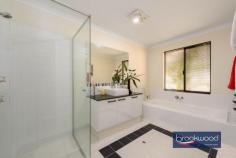  3 Owl Ln Gidgegannup WA 6083 $2,000,000 Perched atop a gentle rise on two hectares, this distinguished residence effortlessly fuses contemporary comfort and country living. The property boasts exceptional amenities and commands serene views across the undulating landscape to a tree-lined dam in the lower corner, creating a picturesque backdrop for daily life. 4 bedrooms 3 bathrooms 2012-built brick and iron Large lock up 2 car garage Extensive bitumen parking area Library office media room Poolside Cabana under main roof Large Alfresco & Entertaining Deck Below ground Solar heated pool 5.2Kw Solar system with 18 panels Plumbed powered man cave/granny flat 10 x 20 3 Phase Powered workshop w 2x hoists Heated spray booth with filtered extraction fan Bore, retic, 3-ph generator 2 hectares, 2 gated entrances Close to Mundaring & Midland shopping precincts Double doors reveal a sophisticated entry hall, where premium porcelain tiles extend across the thoughtfully conceived floor plan. The immediate impression is of space and light; the home’s exemplary attention to detail is evident from the first step inside to be welcomed by the multi-room music system throughout the home. To one side of the entry, a sophisticated media room demonstrates the home’s commitment to modern living. Fully wired for sound and featuring a statement bay window, this versatile space, with its plush carpeting, serves equally well for casual movie nights or more formal gatherings. An expansive open-plan living zone at the heart of the home creates a natural gathering point for family life. The contemporary kitchen is a study in modern elegance, with striking black Essa stone benchtops contrasting beautifully with slim black hardware on the abundant under-bench storage. A 900mm oven and induction cooktop cater to the serious cook, while the white two-door dishwasher maintains the kitchen’s crisp aesthetic. A dedicated coffee bar and walk-in pantry ensure the main workspace remains uncluttered and primed for culinary creativity. The central meals area flows naturally to a spacious family room, where direct access to the large Alfresco area leading to the sheltered below-ground salt pool that creates a seamless connection between indoor and outdoor living. This thoughtful layout epitomises modern Australian living, where every element has been carefully considered to deliver an easy, elegant lifestyle. The thoughtfully arranged accommodation wing extends from the family room via a central hallway. A delightful library with bespoke storage solutions creates a sophisticated retreat with the added luxury of direct pool access. Adjacent, a dedicated home office provides a focused environment for work or study, embodying the home’s commitment to balancing family life with professional needs. The main bedroom suite exemplifies sophisticated living, with sliding doors seamlessly connecting to the pool area. This generous parents’ retreat encompasses a king-sized bedroom finished with quality carpeting, sheers & blockout curtains, a walk-in wardrobe, and a refined ensuite, where fluted glass shower screens, double basins and a separate WC add elements of luxury and privacy. Junior bedrooms demonstrate equal attention to detail, each appointed with mirror-fronted built-in robes and a combination of Roman and Venetian blinds. These rooms are serviced by a bright family bathroom featuring a shower and tub, complemented by a practical arrangement where the separate WC is positioned within the walk-through laundry at the hall’s end. The outdoor living spaces have been curated to create a resort-style environment for year-round enjoyment. The centrepiece is a solar-heated salt pool protected by a shade sails and surrounded by sophisticated entertaining zones. These include a deck with an integrated teppanyaki bar and an air-conditioned cabana with bathroom facilities. Outdoor roll up awnings provide additional climate control, ensuring comfortable use of these spaces regardless of weather conditions. This thoughtful integration of indoor and outdoor spaces, combined with practical amenities and luxurious touches, creates a home where every aspect of modern family life has been carefully considered and catered for. Exemplary residential amenities set a high standard, and the workshop complex and grounds maintain this commitment to excellence, with an array of features elevating this estate beyond the ordinary. The crowning achievement is a magnificent 20m x 10m workshop, designed with 6.5m clearance and comprehensive 3-phase power. Two vehicle hoists and a dedicated spray booth create a premium workspace. This exceptional facility offers limitless potential for both passionate enthusiasts and professionals. A sophisticated ‘man cave’ has been created within the workshop complex which could be easily converted to a granny flat. This retreat has climate control, a complete kitchen, and bathroom facilities. A separate entry opens to a wrap-around verandah, perfect for relaxing after a day of projects. The auxiliary structures continue with a single carport and a powered 6m x 9m garage, complemented by two 40-foot sea containers thoughtfully converted and powered for machinery storage. Together, these create a comprehensive compound for vehicles and equipment. The 2-hectare grounds showcase intelligent planning. Extensive paving surrounds the home, and two substantial rainwater tanks (250,000 and 24,000 litres), a high-yield bore, and a winter dam ensure water security. Carefully placed outbuildings and statuary enhance the landscape, creating visual interest throughout the property. Every aspect of security and convenience has been considered: dual entry points with electric gates, comprehensive reticulation systems, a rooftop fire suppression system, monitored security alarm, CCTV and Intercom systems. 3 phase generator backup and extensive landscape lighting all contribute to a secure, low-maintenance environment. Solar powered hot water system and 5.2kw with 18 solar panels. Zoned reverse cycle air conditioning throughout the primary residence provides the final touch to what is truly a turn-key property. This remarkable Hills residence presents a rare opportunity to acquire a premium lifestyle property where every detail has been meticulously planned and executed, creating an environment where luxury and practicality coexist perfectly. 