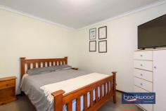  61 Hartung St Mundaring WA 6073 $769,000 A prime location opposite Harry Riseborough Reserve makes this home a walker’s paradise, with parks, trails, schools and shops all nearby. Set on a generous block, the property features light-filled interiors, ample space for alfresco entertaining and a versatile workshop complete with a lean-to and drive-in access. This is an exceptional opportunity to embrace Hills living at its finest, providing the ideal foundation for a relaxed and connected lifestyle. 3 bedrooms 1 bathroom 1972-built brick and tile South-facing family room Updated kitchen/meals Light neutral interiors 6m x 6m shed and lean-to Side access & in-out drive Reverse cycle air-con 1796 sqm lot opp reserve Walk village school sport Set well back from the road, behind an in-out driveway, this Mundaring home presents a welcoming face to the world. The front door opens to reveal a light and cohesive palette of colours and materials. Modern interventions blend seamlessly with original elements in luminous and practical interiors. Timber windowsills and door frames sit comfortably with a muted-toned carpet and practical timber-look vinyl floor in high-traffic areas; sliding doors maximise space and enhance the flow of the layout. At the front of the plan, a family room boasts a large, south-facing window looking onto the natural landscape of the front yard. Reverse cycle air conditioning ensures this central living zone is comfortable throughout the year. This inviting space can be styled as a lounge and dining room, offering flexibility for relaxing or entertaining. Alternatively, the kitchen is generously sized and comfortably accommodates a table. A timeless monochrome palette defines a sleek and modern kitchen. White cabinetry is complemented by striking black benchtops and a tiled splashback, creating a clean and contemporary aesthetic. The stainless-steel finishes of the freestanding electric oven, dishwasher and rangehood add a polished touch, while black hardware on the overhead and under-bench cabinets ties the design together. A white sink provides a crisp contrast, enhancing the overall sophistication of the space. A sliding glass door connects the kitchen and dining area to a private courtyard, which also features convenient gated access from the front of the home. Open off a central hall is a walk-through laundry with a separate WC, a family bathroom with shower and bathtub and three bedrooms. Each boasts soft, muted-toned carpet. Two bedrooms face South, and the third, a junior bedroom, looks out to the backyard. Brick paving extends across the rear and along two sides of the home, creating a pleasant, elevated space for relaxing, serenaded by birdsong and the hum of summer cicadas. Below the rear verandah is a large, paved patio for entertaining. Running along the property’s eastern border is a paved drive leading to the shed and lean-to. Nestled in an exceptional location, this home perfectly captures the essence of life in the Perth Hills. Offering access to schools, sporting fields and the Heritage Trail for kilometres of walking and riding, it places every amenity of a vibrant, well-serviced town right at your doorstep. Surrounded by the beauty of a natural landscape, this move-in-ready property provides a rare combination of comfort and potential, inviting you to create a home that’s your own. 
