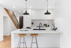  3/4 Medway Street Box Hill North VIC 3129 $1,600,000-$1,700,000 This brand-new dual-level townhouse is a meticulously designed, contemporary offering in one of Box Hill North's most sought-after locations. Just minutes from Box Hill Central's vibrant retail, dining and entertainment precinct, the home is also within walking distance of parks, childcare centres and local employment zones. Zoned for Kerrimuir Primary School and Box Hill High School, it's also perfectly positioned near public transport options. Designed with modern industrial inspiration, the home's striking facade combines textured brickwork with smooth render, creating a bold sophisticated aesthetic. The statement entryway, featuring a recessed porch and oversized timber door, offers a grand yet understated welcome. The black panel-lift garage door integrates into the design. Stunning 2.7m square-set ceilings enhance the sense of space, while opulent herringbone timber flooring flows throughout. The open-plan design is filled with natural light and large black-trimmed glass sliding doors open to a private courtyard. A centrally controlled zoned heating and cooling system ensures year-round comfort, while modern LED downlights illuminate. The ground-floor guest bedroom is a retreat, complete with a study and private ensuite. An external storage shed adds practicality. The decadent kitchen blends industrial chic with refined luxury. A four-seater breakfast island with 60mm marble-look stone, waterfall edging and feature v-panel backboards sits beneath striking black pendant lights. The splashback matches the stone benchtops while a matte-black double bowl sink with a gooseneck flick mixer is sophisticated. Finger-pull gloss white cabinetry and drawers provide storage, while quality 600mm appliances, including a gas burner cooktop, oven and dishwasher, cater to the needs of modern living. A spacious butler's pantry extends the kitchen's functionality, offering additional stone countertops, an extra sink and a second stove. Upstairs, three oversized bedrooms branch off a sunlit retreat, each with generous robe storage and ensuites. The bathrooms are luxurious, featuring floor-to-ceiling wall tiles, vanities with 60mm marble-look stone, avant-garde sink and tapware and fully frameless showers with dual shower heads and niche shelving. The main bedroom's ensuite adds an indulgent freestanding bathtub. Property Highlights: • Brand-new townhouse with high-end finishes • High ceilings, herringbone timber flooring and zoned AC • 60mm stone, quality appliances,butler's pantry 