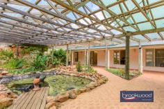  184 Hyde Dr Wundowie WA 6560 $649,000 This modern Wundowie home offers an escape from urban living and an opportunity to embrace a lifestyle connected to nature. It sits on a fully fenced lot with a powered high-clearance machinery shelter and a powered, insulated workshop. Designed for indoor-outdoor living, with an atrium and water feature blurring the distinction between interior and exterior spaces, this home is designed to connect you with your surroundings, encourage a considered pace of life, and deliver the gift of freedom from a 4.87-acre lot. 1/2 bedroom 1 bathroom Flexible retreat/2nd bed 1990s brick clad & iron Indoor-outdoor floorplan Kitchen with huge walk-in Atrium with central pond Pwd machinery shelter Pwd & insulated workshop 4.87-acre fully fenced block Private country escape For those seeking a thoughtful escape from suburban living, this elegant one-bedroom property presents a compelling opportunity to embrace a more considered way of life. Set on almost five gently graded acres and positioned discreetly at the block’s brow, the home offers privacy while maintaining a connection to a community of like-minded residents on similar acreages. The heart of the home is a light-filled central living space that flows seamlessly into a remarkable atrium running the length of one side. This verdant indoor-outdoor room with a tranquil central pond creates a year-round connection to nature while offering a protected space for relaxation and entertaining. At one end of the open plan, the well-appointed kitchen features stone benchtops, a freestanding oven, and a generously proportioned walk-in pantry with dedicated space for a fridge, freezer, and storage of home-grown produce and preserves. Easy-care tiled floors throughout maintain a casual style, while the large, fully tiled bathroom/laundry delivers style and practicality in equal measure. The current principal bedroom with a wall of full-height, mirror-fronted robes and a large east-facing window could be complemented by a second, with an adjoining retreat suited to reconfiguration. The property’s infrastructure supports a self-sufficient lifestyle. A high-clearance powered machinery shed has previously housed trucks, while a powered, insulated, and partitioned shed offers additional possibilities for workshops, studios, or storage. The five acres present endless opportunities for those drawn to productive gardening. There is ample space for a home orchard, vegetable gardens, and keeping chooks. The connection to scheme water makes caring for a productive home garden less fraught. The fully fenced block offers ample space for a large rainwater tank. Just a five-minute drive away, the township of Wundowie offers all essential amenities, including schooling, a swimming pool, and local shops. This ensures the property delivers a balance of rural tranquillity and practical convenience. This property presents a rare opportunity to step away from suburban constraints while maintaining a connection to the community – perfect for those seeking to downsize without compromise or first-home buyers ready to embrace a more intentional way of life. 