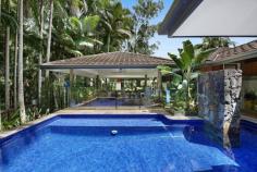  43 Bramley Drive Tallebudgera Valley QLD 4228 Immersed in supreme seclusion and tranquillity, this award-winning rainforest retreat will nourish your soul. Cocooned within 9.2 unspoilt acres and set upon an elevated and concealed plateau, it is a purely private slice of paradise. Hosting a Singaporean pavilion-style residence, the unique home reveals itself as you step through the centuries-old double Indian front doors. Architecturally designed to embrace a centrepiece pool, it's complemented by character-rich hand-built rock walls, hardwood floors and galleries of glass to ensure an ever-present connection to nature. Just as impressive is the seamless indoor-outdoor flow. The open plan kitchen, living, and dining area spills onto an expansive alfresco deck, serving as a protected all-weather living and entertaining zone. Bordered by established foliage and softly streaming water features, host guests in style, relax to the soothing sounds of nature or even indulge in your daily yoga routine. Beyond, the tiled pool promises rejuvenation or meander the grounds to where multiple charming spots cater to relaxing and reflecting amongst the lush greenery. In cooler months, unwind fireside in the lounge room, where blissful bushland views wrap around its exterior, or settle back on the day bed built into the master suite, overlooking the meditative beauty of the outdoors. A second bedroom with a stylish ensuite, built-in robe, and private deck provides a serene space for guests or family. A natural wonderland that requires minimal upkeep, this means more time to explore the walking trails that meander through the virgin landscape or enjoy the equestrian amenities. Additionally, with a spring creek, fruit trees, herb garden, veggie patch, and ample water storage, it also offers a taste of sustainability. An estate that feels far removed from the urban sprawl, you'll be surprised to find schools, shops and parks are close by. You can even feel the sand beneath your toes in under 20 minutes! Experience its pure peace, beauty and privacy for yourself – inspect today. House Features: Elevated, award-winning tropical rainforest hideaway tucked away in unsurpassed privacy and tranquillity Singaporean U-shaped pavilion-style architecture, with the single-level home encasing a centrepiece pool Galleries of glass throughout ensure an ever-present connection to nature Rich with character and warmth, boasting centuries old double Indian front doors, hand-built rock walls and hardwood floors Open plan kitchen, living and dining zone spills onto an expansive entertaining deck Lounge room captures lush bushland views and includes a cosy fireplace Spacious master suite featuring a modern ensuite and a built-in day bed overlooking the emerald greenery outdoors Second bedroom with a stylish ensuite, built-in robe and private deck Sprawling covered alfresco deck cocooned by established foliage and softly streaming water features – acts as an all-weather living and entertaining zone Tiled pool with rock feature wall Multiple outdoor areas to relax and reflect amongst the lush greenery Double carport Laundry with a handy extra powder room Air-conditioning and ceiling fans Property Features: Supremely secluded 9.2 acre estate completely hidden from the street Low-maintenance virgin rainforest landscape includes walking trails and a spring creek Natural wonderland, where you'll find king parrots, koalas and wallabies at play Established fruit trees, organic herb garden and veggie patch 3m x 3m shed Fully fenced horse paddock plus a tack room and stable 35,000L and 13,000L water tanks Location: Approx. 2 mins to Ingleside State School Approx. 4 mins to Harley Smith Reserve Approx. 10 mins to Tallebudgera State School and shops Approx. 10 mins to St. Andrew's Lutheran College Approx. 17 mins to The Pines, Elanora Approx. 19 mins to Burleigh Heads Approx. 21 mins to Currumbin Beach Approx. 23 mins to Gold Coast Airport 