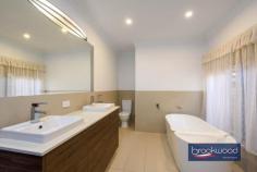  900 Kintore Rd Parkerville WA 6081 $1,050,000 Discover the perfect retreat on this stunning 5.07-acre native bush block, where tranquillity meets opportunity. Nestled at the end of a quiet cul-de-sac, this beautifully elevated 3×2 plus study or optional fourth bedroom brick and iron farmhouse-style home blends seamlessly into its natural surroundings. A meandering driveway leads you through the trees, unveiling a secluded sanctuary with a split-level floorplan, offering flexibility and charm. Enjoy the serenity of nature while still having the convenience of a powered workshop and 2.05 hectares of land, zoned RR1—providing exciting subdivision potential. Whether you’re seeking a peaceful lifestyle or an investment opportunity, this Parkerville gem offers privacy, space and endless possibilities. 3 bedrooms 2 bathrooms Plus study/4th bedroom 1980-built brick and iron Secluded bush setting High ceilings, exp beams AC, open fire, SC fireplace Central courtyard, patio 11m x 9m pw’d wkshop 5.07-acres with RR1 zoning Potential for subdivision Entry to this distinctive Perth Hills residence via a slate-tiled foyer, where arching jarrah steps and a gracefully curving wall announce a home unlike any other. This spacious multi-level property offers a unique layout, providing a canvas ready for your vision. The spacious kitchen and meals area, with a practical central island and twin electric wall ovens, provides a functional workspace where family dinners can be easily prepared. It is easy to imagine how this space could transform into an entertainer’s dream kitchen that becomes the true heart of this distinctive home. Adjacent is a generous mudroom/laundry with the potential to become a sophisticated scullery or butler’s pantry, enhancing both functionality and appeal for modern living. A versatile carpeted room with a slow-combustion fire and direct access to the sheltered patio could serve as an intimate snug on winter evenings, a dedicated library housing your collection or welcoming guest accommodation with its own entry. Teenagers will immediately recognise the potential for privacy here, with the adjoining office space completing a secluded domain away from the main living areas. The formal dining room overlooks a central courtyard, creating a sophisticated setting for dinner parties. Steps lead to a lateral family room with a quartet of tall windows that capture northwest light, complemented by an open fireplace for winter gatherings. Exposed beams and high ceilings accentuate the sense of volume in this central living area, while split-system air conditioning ensures year-round comfort. Slide open the glass door to access the central courtyard and indoor-outdoor living becomes seamless. The bedroom wing occupies a secluded section of the property, offering a peaceful retreat from daily activities. Three carpeted bedrooms, each appointed with built-in robes and individual climate control, provide comfortable accommodation for family or guests. The recently updated family bathroom presents a modern oasis with its soaking tub and double vanity, while a second WC off the laundry/mudroom offers practical convenience. The principal bedroom features its own ensuite. Step outside to discover the large, paved entertaining zone extending from the southern aspect of the home. Sheltered and edged with garden beds, this space invites long evenings of outdoor dining and conversation. Additional outdoor retreats include a charming gazebo and the central courtyard, each offering different perspectives to appreciate the natural beauty surrounding the home. The 11m x 9m powered workshop at the upper boundary, with a 4m high entry clearance is accessible via a pair of gates, serves practical needs well. With its concrete floor, lean-to and dedicated storage room, this multipurpose space is ready for your hobbies, projects or additional vehicle storage. As compelling as the home’s unique design is the 5.07-acre lot itself – a natural sanctuary of eucalypts, she-oak, zamia and seasonal wildflowers. The RR1 zoning presents a significant opportunity for subdivision, allowing you to maintain your private retreat while potentially capitalising on the development potential. This property represents a rare combination of immediate liveability and the promise of transformation into one of Perth Hills’ most notable residences—a chance to create a landmark home that perfectly balances architectural interest with the natural splendour of its setting. 