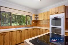  900 Kintore Rd Parkerville WA 6081 $1,050,000 Discover the perfect retreat on this stunning 5.07-acre native bush block, where tranquillity meets opportunity. Nestled at the end of a quiet cul-de-sac, this beautifully elevated 3×2 plus study or optional fourth bedroom brick and iron farmhouse-style home blends seamlessly into its natural surroundings. A meandering driveway leads you through the trees, unveiling a secluded sanctuary with a split-level floorplan, offering flexibility and charm. Enjoy the serenity of nature while still having the convenience of a powered workshop and 2.05 hectares of land, zoned RR1—providing exciting subdivision potential. Whether you’re seeking a peaceful lifestyle or an investment opportunity, this Parkerville gem offers privacy, space and endless possibilities. 3 bedrooms 2 bathrooms Plus study/4th bedroom 1980-built brick and iron Secluded bush setting High ceilings, exp beams AC, open fire, SC fireplace Central courtyard, patio 11m x 9m pw’d wkshop 5.07-acres with RR1 zoning Potential for subdivision Entry to this distinctive Perth Hills residence via a slate-tiled foyer, where arching jarrah steps and a gracefully curving wall announce a home unlike any other. This spacious multi-level property offers a unique layout, providing a canvas ready for your vision. The spacious kitchen and meals area, with a practical central island and twin electric wall ovens, provides a functional workspace where family dinners can be easily prepared. It is easy to imagine how this space could transform into an entertainer’s dream kitchen that becomes the true heart of this distinctive home. Adjacent is a generous mudroom/laundry with the potential to become a sophisticated scullery or butler’s pantry, enhancing both functionality and appeal for modern living. A versatile carpeted room with a slow-combustion fire and direct access to the sheltered patio could serve as an intimate snug on winter evenings, a dedicated library housing your collection or welcoming guest accommodation with its own entry. Teenagers will immediately recognise the potential for privacy here, with the adjoining office space completing a secluded domain away from the main living areas. The formal dining room overlooks a central courtyard, creating a sophisticated setting for dinner parties. Steps lead to a lateral family room with a quartet of tall windows that capture northwest light, complemented by an open fireplace for winter gatherings. Exposed beams and high ceilings accentuate the sense of volume in this central living area, while split-system air conditioning ensures year-round comfort. Slide open the glass door to access the central courtyard and indoor-outdoor living becomes seamless. The bedroom wing occupies a secluded section of the property, offering a peaceful retreat from daily activities. Three carpeted bedrooms, each appointed with built-in robes and individual climate control, provide comfortable accommodation for family or guests. The recently updated family bathroom presents a modern oasis with its soaking tub and double vanity, while a second WC off the laundry/mudroom offers practical convenience. The principal bedroom features its own ensuite. Step outside to discover the large, paved entertaining zone extending from the southern aspect of the home. Sheltered and edged with garden beds, this space invites long evenings of outdoor dining and conversation. Additional outdoor retreats include a charming gazebo and the central courtyard, each offering different perspectives to appreciate the natural beauty surrounding the home. The 11m x 9m powered workshop at the upper boundary, with a 4m high entry clearance is accessible via a pair of gates, serves practical needs well. With its concrete floor, lean-to and dedicated storage room, this multipurpose space is ready for your hobbies, projects or additional vehicle storage. As compelling as the home’s unique design is the 5.07-acre lot itself – a natural sanctuary of eucalypts, she-oak, zamia and seasonal wildflowers. The RR1 zoning presents a significant opportunity for subdivision, allowing you to maintain your private retreat while potentially capitalising on the development potential. This property represents a rare combination of immediate liveability and the promise of transformation into one of Perth Hills’ most notable residences—a chance to create a landmark home that perfectly balances architectural interest with the natural splendour of its setting. 