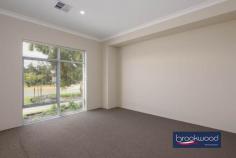  31 Armitage Cl South Guildford WA 6055 $799,000 Positioned in an established neighbourhood of Rosehill Waters Estate, this contemporary home delivers modern family living. A charming front lawn, mature street plantings, and the nearby playground set the stage for a lifestyle that balances urban convenience with a sense of community warmth. 4 bedrooms 2 bathrooms 2023 built brick and iron Stylish contemporary design Environmentally design features Open plan lateral living zone Side access gate to rear 2-car garage with shoppers Sheltered patio fenced yard 446 sqm estab streetscape Park and shopping nearby Step inside to discover a home meticulously designed for contemporary living. The inviting entry opens to a plush, carpeted media room – a dedicated haven for movie nights, gaming adventures, or moments of uninterrupted screen time. A central hallway serves as the home’s backbone, leading to an expansive lateral living space at the rear. Large, soft grey floor tiles anchor much of the layout. Opening off the central hall are three junior bedrooms, each with carpet and built-in robes. These rooms share the fully tiled family bathroom and a separate WC. The principal suite emerges as a true retreat – a walk-through robe leading to a fully tiled ensuite complete with a separate WC offers a private sanctuary of comfort and style. The rear of the home showcases its lifestyle-oriented design, with a well-appointed kitchen taking centre stage. It includes a composite stone benchtop and an island with an integrated breakfast bar, an induction cooktop and oven, and a dishwasher. A walk-in pantry along with under-bench and overhead storage ensures that functionality never compromises style. The soft organic tones of the benchtop and cabinetry blend beautifully with the sophisticated grey floor tiles. A sliding glass door opens to the sheltered patio, a private zone that overlooks a central lawn edged with mass plantings and a colourbond fence, along with a gated side access. This area expands the practical living space and invites relaxation, family gatherings, and quiet contemplation. Practical touches abound, including a paved drive leading to a double garage with remote entry, a convenient shoppers’ entry, and a multi-zone reverse cycle ducted air conditioning – thoughtful details that elevate everyday living. Open the door to a home that understands the nuanced rhythms of family life, where design serves lived experience, offering a framework for daily moments, for connection, and for the quiet and loud celebrations of family. 