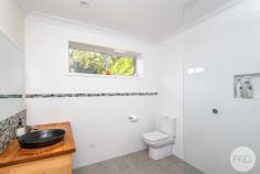  5 Ocean Beach Road Shoal Bay NSW 2315 Nestled in a sought-after pocket of Shoal Bay and just a short stroll to the pristine sands of Box Beach, this beautifully renovated, single-level home offers the ultimate in relaxed coastal living. With Shoal Bay Beach and the buzzing local CBD also just moments away, this home boasts a location that's hard to beat - perfect for families, retirees, or as a holiday escape. Step inside to discover a fresh interior, where natural elements and sleek design come together seamlessly. The home features four generously sized bedrooms and three stylish bathrooms, each finished with floor-to-ceiling white tiles and warm wooden vanities, creating a calming and cohesive aesthetic throughout. At the heart of the home is an open plan kitchen, dining, and living area that flows effortlessly to the outdoors. The kitchen is splashed with sunshine with stunning sky lights and timber-accented design with beautiful wooden cabinetry complemented by large windows and glass sliding doors that fill the space with natural light and provide a view of the leafy backyard. Whether you're entertaining, unwinding, or making the most of Shoal Bay's beachside lifestyle, this home offers an exceptional combination of comfort, style, and location not to mention being less than a 5 minute walk to Box Beach. With rear lane access, this home will appeal to anyone who is seeking parking for a caravan or large trailer boat. 