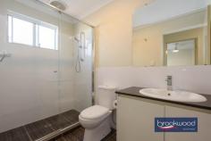  Unit 4/23 Coongan Ave Greenmount WA 6056 $599,000 Discover the magic of a well-considered floor plan, a cohesive palette of colours and materials, and an incredibly convenient location. Nestled within a small, secure complex, this contemporary strata unit presents an enviable lifestyle opportunity. Positioned opposite a reserve and mere steps from the Heritage Trail, the property combines the best of urban convenience with a sense of peaceful retreat. Low strata fees, a private outdoor entertaining space, and a two-car garage with storage elevate this impeccably presented unit above the ordinary. 3 bedrooms, 2 bathrooms 2017-built brick and iron Open-plan kitchen lounge Kitchen w stone benchtops Sep junior bedroom wing Alfresco entertaining UMR 2-car garage with shoppers’ Secure 206 sqm block Low maintenance living Close airport Midland Trail A small front garden behind a low wall leads to this nearly new unit’s front door and entry hall. To one side, the principal suite, and to the other, a shoppers’ entry from the two-car garage. A split-level design creates a clever separation of spaces, with the principal suite strategically positioned to offer a tranquil retreat from the home’s social areas. The main bedroom is a sanctuary featuring plush carpeting, an elegant ceiling fan, a spacious walk-in robe, and a chic ensuite that elevates your daily routine. Steps lead up to the open-plan kitchen, meals, and family room. High ceilings and large windows ensure this central living zone is filled with natural light. A generous sliding door dissolves the boundary between indoor comfort and outdoor freedom, inviting the landscape into each day. A carefully curated colour palette creates visual harmony throughout the home. Crisp white walls provide a clean backdrop for sophisticated grey undertones, complemented by subtly patterned floor tiles, plush bedroom carpeting, and elegant stone benchtops that tie the entire home together with a cohesive design. In the generously proportioned kitchen, a splashback of textured white tiles echoes the sleek finish of high-gloss cabinets topped with a U-shaped stone benchtop. A built-in pantry, overhead and under-bench storage, an electric oven, and a gas hob provide cooks with everything they need to excel in their culinary adventures. A private courtyard-style garden at the home’s northeast corner extends your living space. It includes a paved dining area partially sheltered under the main roof, perfect for alfresco entertaining and seamless indoor-outdoor living. The home’s junior wing offers two well-appointed bedrooms, each with built-in wardrobes and one with a ceiling fan. A generous family bathroom, convenient walk-through laundry, and substantial linen storage complete the practical design. From the convenient two-car garage to the meticulously designed interior, this home represents modern living at its finest – where every detail combines to create a beautiful and brilliantly functional space. First home buyers, FIFO workers and downsizers, your new lifestyle awaits, offering comfort, style, and an unparalleled living experience. 