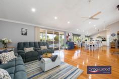  117 O'Driscoll St Bakers Hill WA 6562 $899,000 Blending elegant design with the tranquillity of nature, this magnificent Queenslander-style home redefines country living. Open-plan living, a below-ground pool, a powered workshop and a beautiful garden setting combine to create a dream 2.6-acre sanctuary, offering the perfect canvas for your family’s most cherished memories. 4 bedrooms 2 bathrooms 2007-built Hardi and iron Wrap-around wide verandahs Gourmet kitchen & island Home theatre Ducted air con, insulation Salt-water B/G swimming pool 9m x 6m powered workshop 2.6-acre country estate This picturesque Queenslander sits proudly amongst thoughtfully arranged plantings, orchards and paddocks. The home’s classic wide verandahs and welcoming pitched portico immediately evoke a sense of timeless elegance and arrival. Step inside to discover the honeyed tones of Blackbutt timber flooring. The open-plan living space impresses with its soaring raked ceiling and bright, airy atmosphere – a sanctuary where you can exhale and unwind. Year-round comfort is ensured with a reverse-cycle air conditioner for summer respite and a magnificent slow-combustion burner with wetback system that becomes the heart of the home during winter evenings. The gourmet kitchen features shaker-style cabinetry that provides abundant storage and expansive preparation areas. The substantial breakfast bar and island bench create perfect gathering spaces, while premium appliances, including the show-stopping 900mm Artuzi oven, inspire culinary creativity. Adjacent to the kitchen, elegant French doors reveal a dedicated home theatre with a projector and screen – an exceptional space for regular movie nights. The sumptuous primary suite is a king-sized haven with a generous walk-in robe and a classically appointed ensuite with a deep soaking tub, shower and private WC. A door opens to a private decked verandah – your oasis for savouring morning coffee amidst native bird-attracting gardens and the soothing sounds of a tranquil pond. Three additional bedrooms offer spacious and spacious privacy at the residence’s rear. Each room boasts premium Tasmanian oak blinds, plush 100% wool carpeting and built-in storage. A well-appointed family bathroom and substantial laundry complete this wing, ensuring comfort and functionality. This exceptional property anticipates your every desire with thoughtful amenities throughout. Ducted evaporative air conditioning maintains perfect comfort, while the integrated solar hot water and photovoltaic systems harness nature’s energy, reducing environmental impact and costs. The property connects to scheme water, supplemented by discreetly positioned 2500L water tank. An eight-zone automatic reticulation system maintains the lush landscape with minimal effort. The sparkling below-ground salt-water pool offers a refreshing retreat during warmer months. A sheltered deck creates the ideal setting for alfresco entertaining and casual gatherings beneath the stars. Embrace the authentic Hills lifestyle with meticulously planned outdoor spaces, including fenced paddocks, a charming chicken coop and a productive vegetable garden that promises farm-fresh bounty throughout the seasons. The substantial 9m x 6m powered workshop – complete with dedicated bathroom facilities and water connection – provides endless possibilities for projects, hobbies or additional storage. Located moments from local amenities and the renowned Bakers Hill Bakery, this remarkable property offers the perfect balance of seclusion and convenience. The secret of this extraordinary Queenslander awaits your discovery – an unparalleled opportunity to embrace the country lifestyle you’ve always envisioned. 
