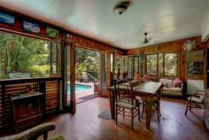  265 Jackson Road Shell Pocket QLD 4855 $750,000 "Rum Jungle" as it's affectionately named, is a secluded, yet not remote rainforest hideaway just 20 minutes from the tropical paradise of Mission Beach. Approximately 4 acres of this 8 acre (3.35 ha) property is cleared to form lush tropical gardens, lawns and a 2 story home, freestanding extra bedroom/office, pool, garaging for 5 vehicles and an authentic Balinese hut. Access is via a bitumen rural road and a good all weather gravel road through tunnels of lush rainforest. Cairns Domestic and International Airport is 90 minutes north along National Highway 1. Within a radius of 10 - 20 mins travel there are the following amenities: The El Arish Tavern, Roadhouse (under construction), beautiful golf course, 14 km coastal strip of Mission Beach with its Clump Point Boating Harbour and 12 tropical islands (including Dunk and Bedarra), coral reefs, Post Office and Shops. "Rum Jungle "is off grid with the latest (6-month-old) 9 KVA solar system including battery storage plus a 5 KVA system with its own battery storage as well ...all sufficient to power air conditioning, washing machine, pool pump, power tools etc Other features of this remarkable property include: - Freehold acreage with estimated 300-400 m of permanent creek frontage( Maria Creek) and frontage to State Forest. - 20 - 30 mins to doctors, hospitals and services (in Mission Beach, Tully or Innisfail) -The major provincial town Innisfail is approx.. 40 minutes to the north and Tully approx. 20 mins to the south - Exotic all timber and steel construction of improvements - Pool side office/bedroom and sunroom - Furniture and machinery available including tractor, implements, generators, pumps, power tools and more - 6 water tanks provide more than adequate quality water from pristine Maria Creek - A selection of tropical fruit trees including clumps of delicious Cavendish Banana trees are spread throughout the property. "Rum Jungle" is a nature lovers paradise with a fascinating array of native animals including the giant Cassowary, colourful pigeons, vibrant butterflies, platypusses, wallabies and numerous bird species. Absolutely stunning neighbourhood of valleys and rainforest clad mountain ranges. Only a handful (about 6) owners share this stunningly beautiful valley, all on private small acreages. Crystal clear swimming holes and white sandy riverbanks are at your disposal to cool off. Extremely private, quiet and serene location. The Property is located on a "no through" road (Jackson Rd (North) towards the head of a spectacular valley. The access road is maintained by the local Shire Council. This property is seriously for sale as the owners have a firm commitment to buy a property interstate. It is an extremely rare find! Time to Plan your Escape! Don't Miss Out! 