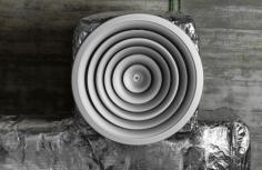  A close-up view of a modern industrial exhaust fan installed on a building wall, highlighting newly fitted Exhaust Fan Seals around its perimeter. The seals appear tightly secured, made from durable, weather-resistant materials. A soft glow emphasizes the airtight fit, symbolizing reduced air leakage. In the background, a graph overlay subtly illustrates improved airflow control and cost savings, representing the impact of Energy Efficiency Upgrades . Text labels point out key benefits: "Boost Performance" and "Block Leaks," emphasizing the role of high-quality sealing solutions in energy conservation. 