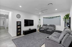  25 King Street Coomera QLD 4209 This is your chance to secure something genuinely special: the very first home to come to market on Coomera’s newly established King Street. Built in 2021, 25 King Street offers a smart layout, quality finishes, and a peaceful location that’s becoming one of the suburb’s best-kept secrets. Set on a 405m² block, the home feels spacious from the outset – high ceilings, wide entry, and plenty of natural light create an open and comfortable environment from the moment you step inside. There are two separate living areas, making it ideal for young families, couples working from home, or anyone who values a bit of breathing room. The central living space flows into a modern kitchen with stone benchtops, quality appliances, and a clean, minimalist design. It connects seamlessly to the outdoor alfresco area – perfect for easy entertaining or just enjoying a quiet afternoon outdoors. All four bedrooms are generous in size, with the master positioned at the rear for extra privacy. A walk-in robe and sleek ensuite round out the retreat-like feel, while the main bathroom also features floor-to-ceiling tiling and a sharp, modern finish. Ducted air conditioning runs throughout the home, keeping the temperature just right year-round. The property is also fitted with a 13.2kW solar system, a noteworthy inclusion that enhances the home’s overall efficiency. Whether for day-to-day living or future-proofing against rising energy demands, it’s a practical and forward-thinking feature. King Street itself is quiet, elevated, and surrounded by other well-maintained homes – a great environment for families or buyers wanting to step into a location with real long-term value. You’re only minutes from Coomera Westfield, local schools, parks, and the M1, but tucked away just enough to enjoy real peace and privacy. Key Features: • Built in 2021 • Four bedrooms, two bathrooms • Two separate living areas • Ducted air conditioning • High ceilings and wide hallway • Open-plan kitchen with stone benchtops • Covered outdoor entertaining area • 405m² block, fully fenced backyard • Double garage with internal access This isn’t just a new listing – it’s a rare opportunity to secure the first home in what’s shaping up to be one of Coomera’s most desirable streets. If you’ve been waiting for something with genuine quality, in a location with long-term upside, this is the one. 