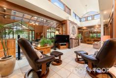  94 Tanahmerah Rd Balhannah SA 5242 Timeless elegance radiates with abundance around this stunning Carey Gully stone and brick residence surrounded by gorgeous English cottage gardens and the rolling hills of Balhannah. An exquisite marble entrance complete with delicate lead light windows opens up to a breathtaking home designed to provide both luxury and comfort, while amplifying the stunning surrounds of designer garden and natural bushland. The entrance of the residence opens up to an expanse of living and dining spaces, all surrounding a warm and light filled atrium at the heart of the home. A formal lounge and dining room present a picturesque space to entertain in comfort while the glass and timber atrium, equipped with underfloor heating is a testament to the meticulous attention to detail and functionality that characterise this home. The timeless parquet floors that flow throughout the home are complimented by the floating floorboards that grace the kitchen and dining areas. Four generous bedrooms surrounding the central atrium offer ample space for living and storage along with charming views of the surrounding scenery, while the majestic master suite boasts an elegant bathroom and spacious walk-in robe. The flexibility of the layout allows for a configuration of three bedrooms or the option to create a study space for those seeking a home office. Moving through the retreat style atrium, a grand American Oak kitchen hosts a large walk-in pantry, Belling oven and exhaust fan, and a Miele dishwasher. This space is enhanced by a spacious casual dining area featuring a Coalbrook Dale Wood Fire heater and surrounding scenic views to the manicured garden and rolling hills. Looking through the numerous, generous windows, an expansive verandah highlighted by hand-made terracotta edging tiles wraps around the home. Its 40 solar panels, ducted air conditioning and vacuum system further ensure eco-friendly, efficient and comfortable living. Beyond the immediate residence, the property unfolds into 25 acres of scenic beauty featuring 2 acres of meticulously maintained English Cottage style gardens. An automatic watering system and fully lit garden with lanterns and floor lights enrich the natural botanical splendour. At the southern aspect of the home, a large, light filled conservatory, surrounded by floor to ceiling glass walls, sets the stage for alfresco dining. With a fully-functional kitchen, the curated entertainment space caters for grand occasions, with space to seat sixty people in a round dining table setting. The exceptional functionality of the property is supported by a billabong, dam, bore and a valuable water license, adding convenience and potential to the opportunity. A farm shed, woodshed, and a double garage with automated doors offer abundant storage. The plot also homes 100 nut trees and 20 cherry trees, contributing to the landscapes breathtaking natural charm while delivering stunning views of native bushland. Set against this picturesque backdrop, this stunning residence is a perfect blend of classic charm and modern refinement, offering an idyllic retreat to unwind and entertain in style. This is a property that perfectly encapsulates the essence of luxury country living while remaining a testament to functional design. Location Highlights: + Situated on the scenic Mt George side of Balhannah + 10 minutes commute to the city + Close to iconic venues such as the Stanley Bridge and Uraidla Hotels, Hahndorf Hill winery and Ambleside Distillery +Zoned for Uraidla, Bridgewater and Oakbank Primary Schools, plus close to the Hills Christian and Cornerstone Colleges. 