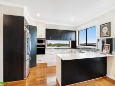  17 Brooks Terrace Kanahooka NSW 2530 $1,175,000 - $1,250,000 A large family home in a sought after location presents here at 17 Brooks Terrace, Kanahooka. Perfect for a large family, this split level home has a functional floorplan that provides plenty of space and privacy and a downstairs bedroom/ living space that is perfect for elderly guests or for teenagers wanting to entertain friends. With captivating views of Lake Illawarra from the gorgeous kitchen/ dining area, this is the space that friends and family will want to be entertained. Located just minutes to schools, shops, public transport. freeway access, Dapto CBD, Dandaloo Hotel and the Lake Illawarra foreshore, this is an opportunity not to be missed.' Featuring • 4 Bedrooms • Master with walk in wardrobe and ensuite • Downstairs bedroom, rumpus, bathroom and storage • Gorgeous kitchen with Views of the Lake • Spacious living areas • Study • Double Garage • Lake Illawarra Views • 491sqm corner block in a quiet estate 